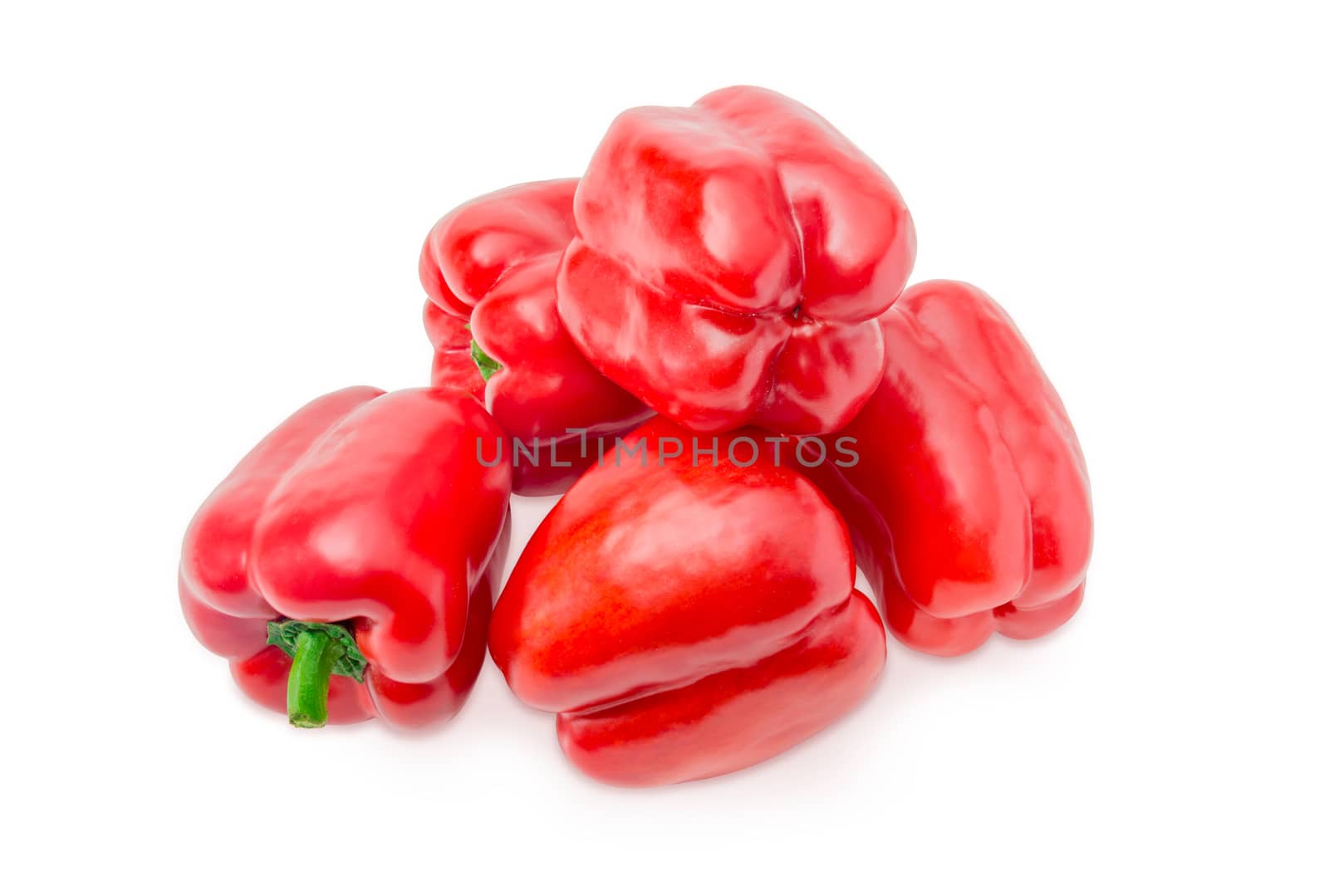 Pile of the fresh red bell peppers on a white background closeup
