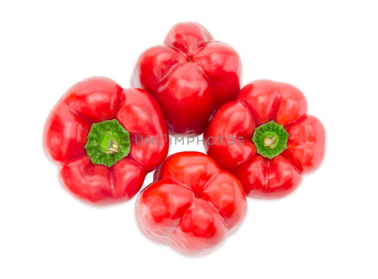 Top view of four fresh red bell peppers on a white background closeup
