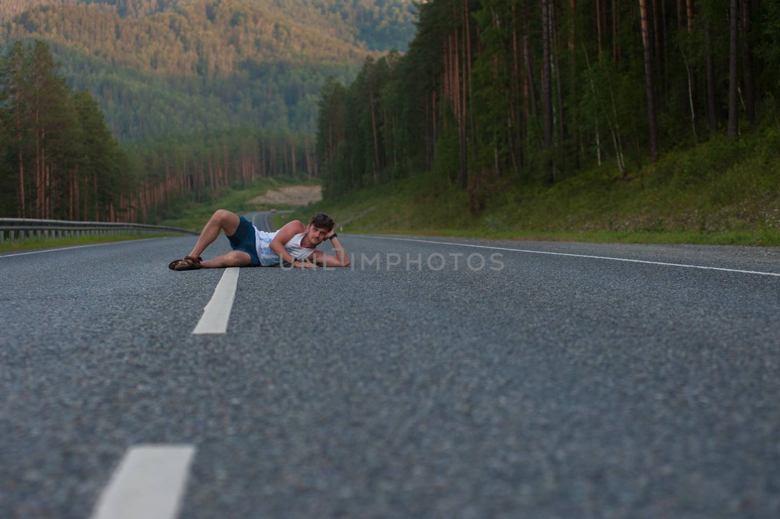 Man laying on the beauty road in mountain