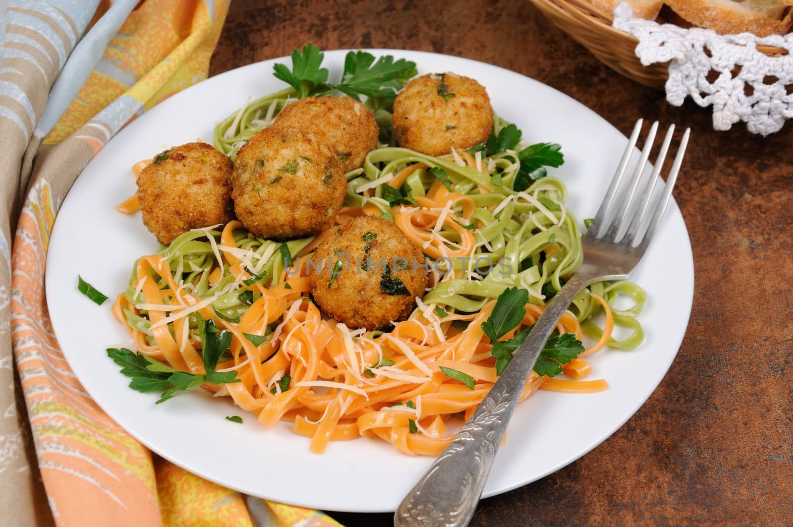 Spaghetti from carrots and spinach with chicken meatballs flavored cheese parmesan, herb