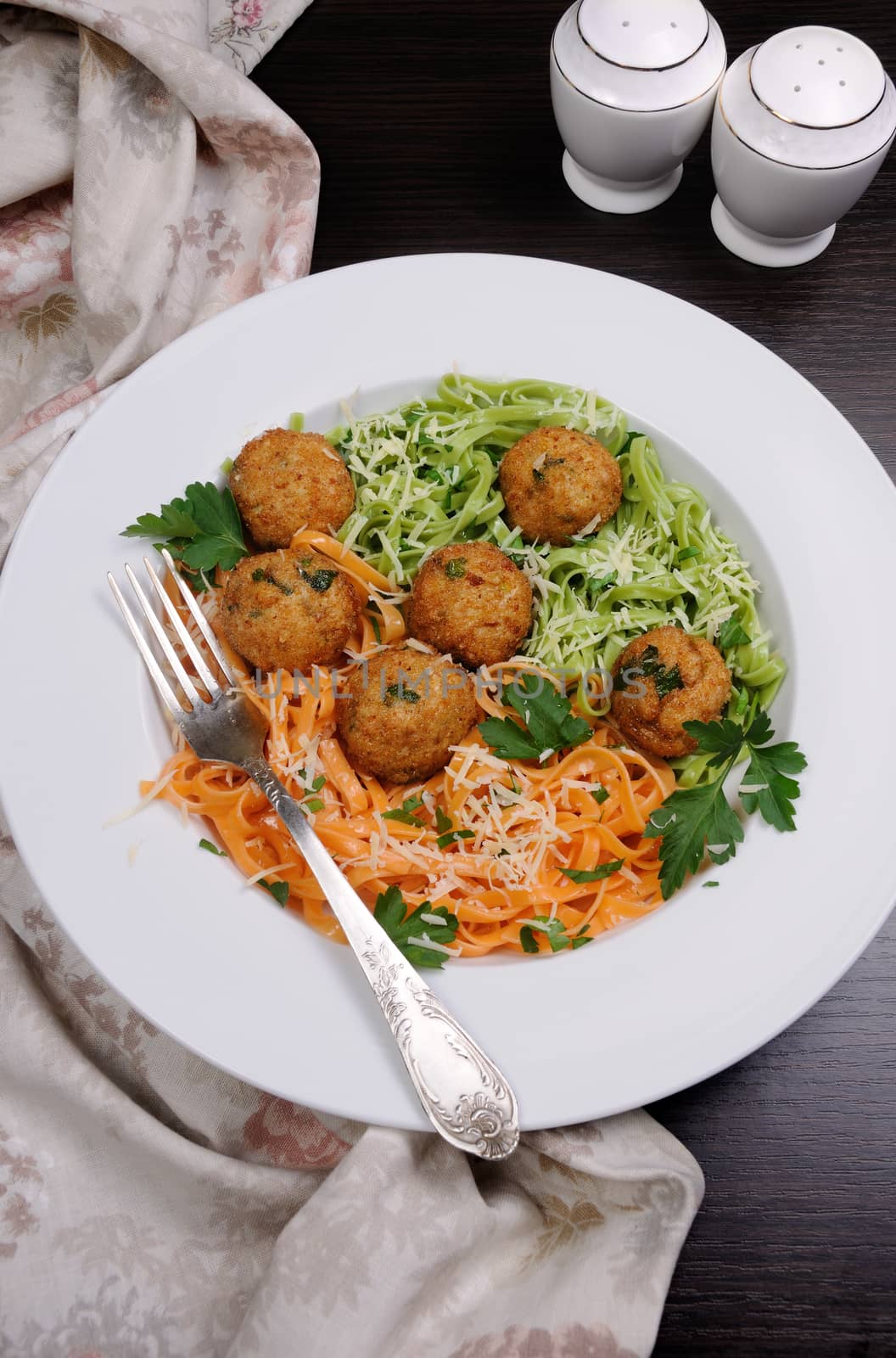 Spaghetti from carrots and spinach with chicken meatballs flavored cheese parmesan, herb