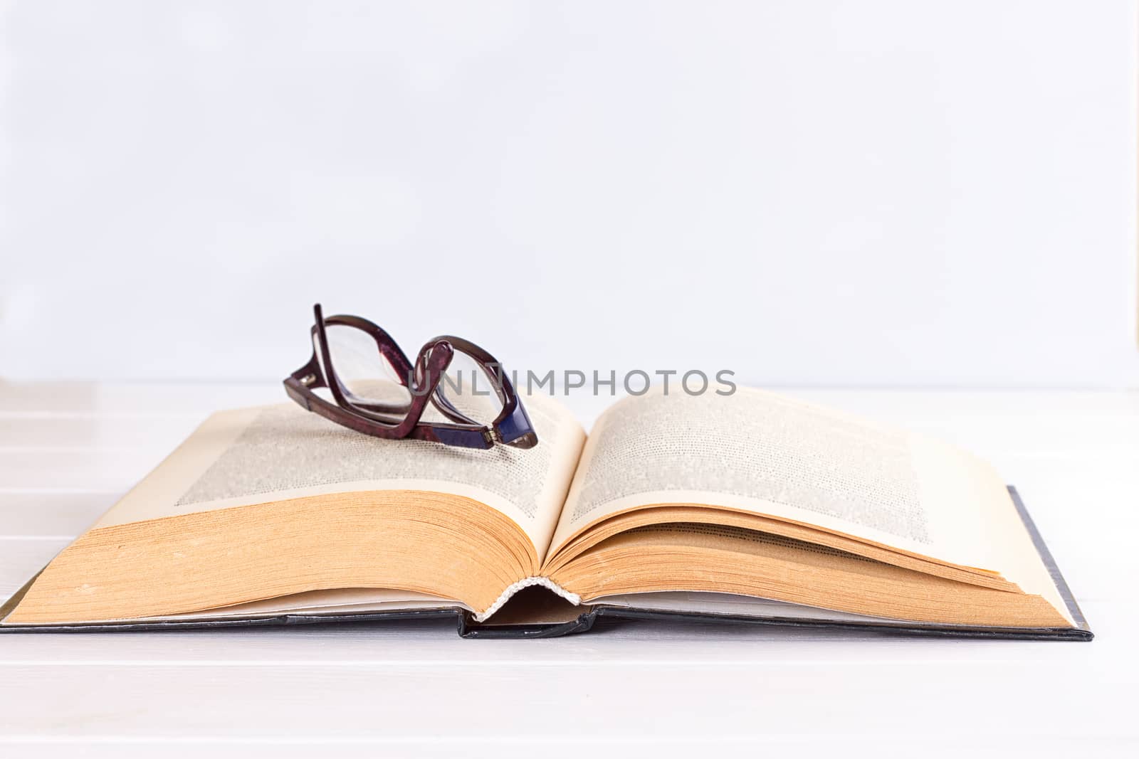 glasses and book on the white background