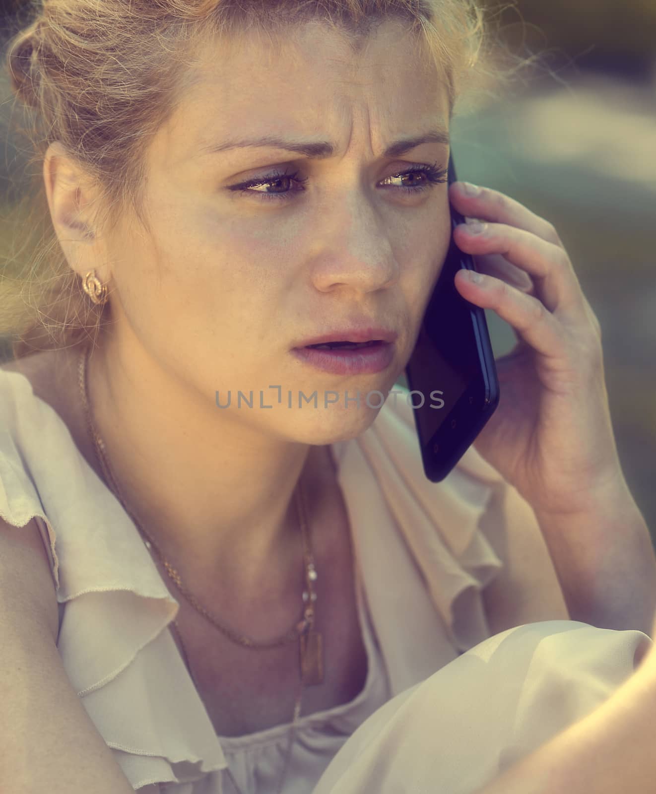 Girl talking on phone and being shocked.