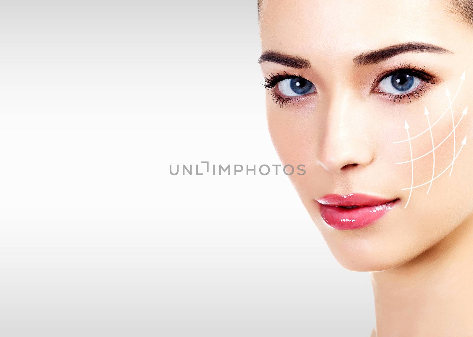 Pretty woman against a grey background with copyspace