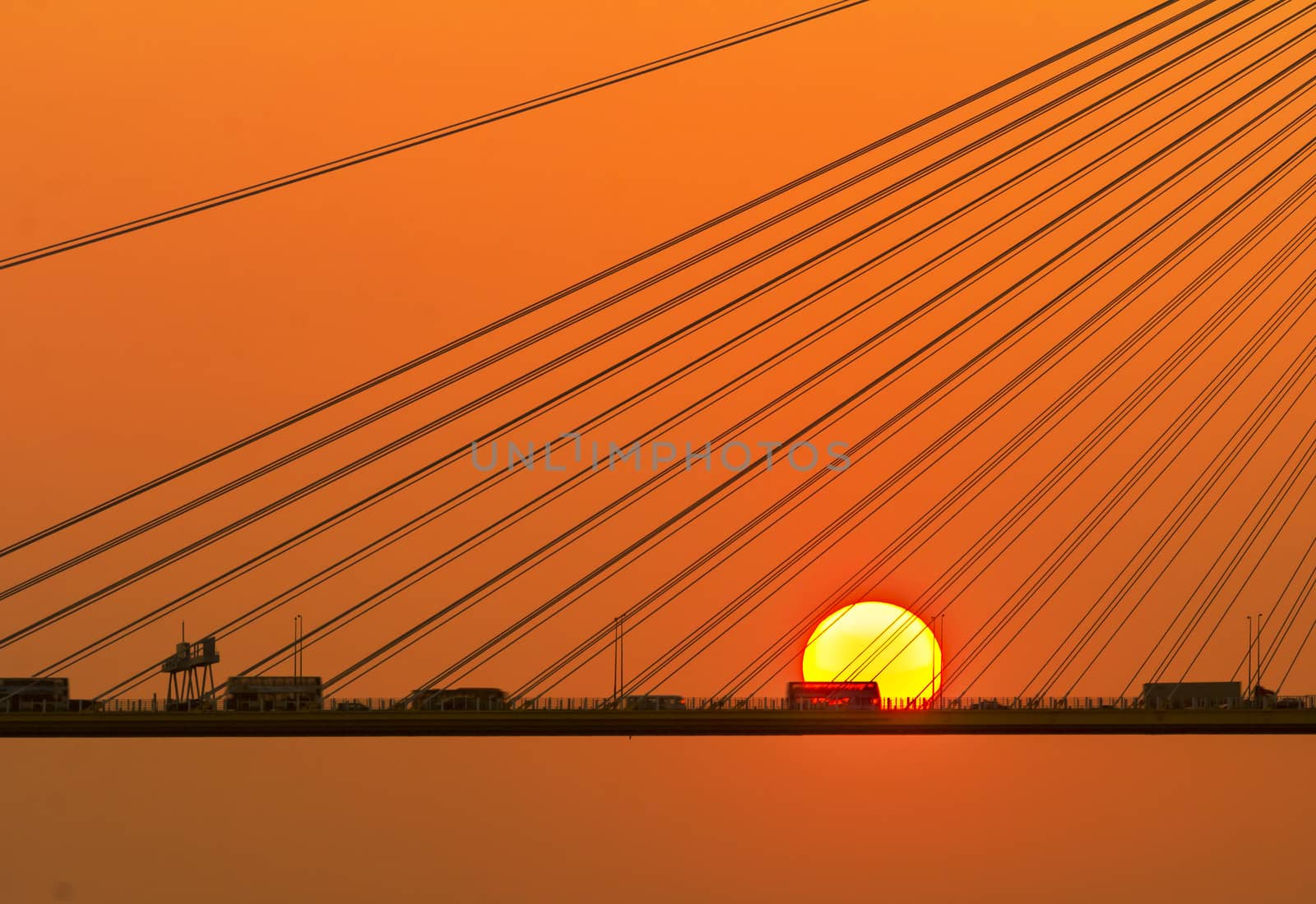 Silhouette of a bridge under setting sun