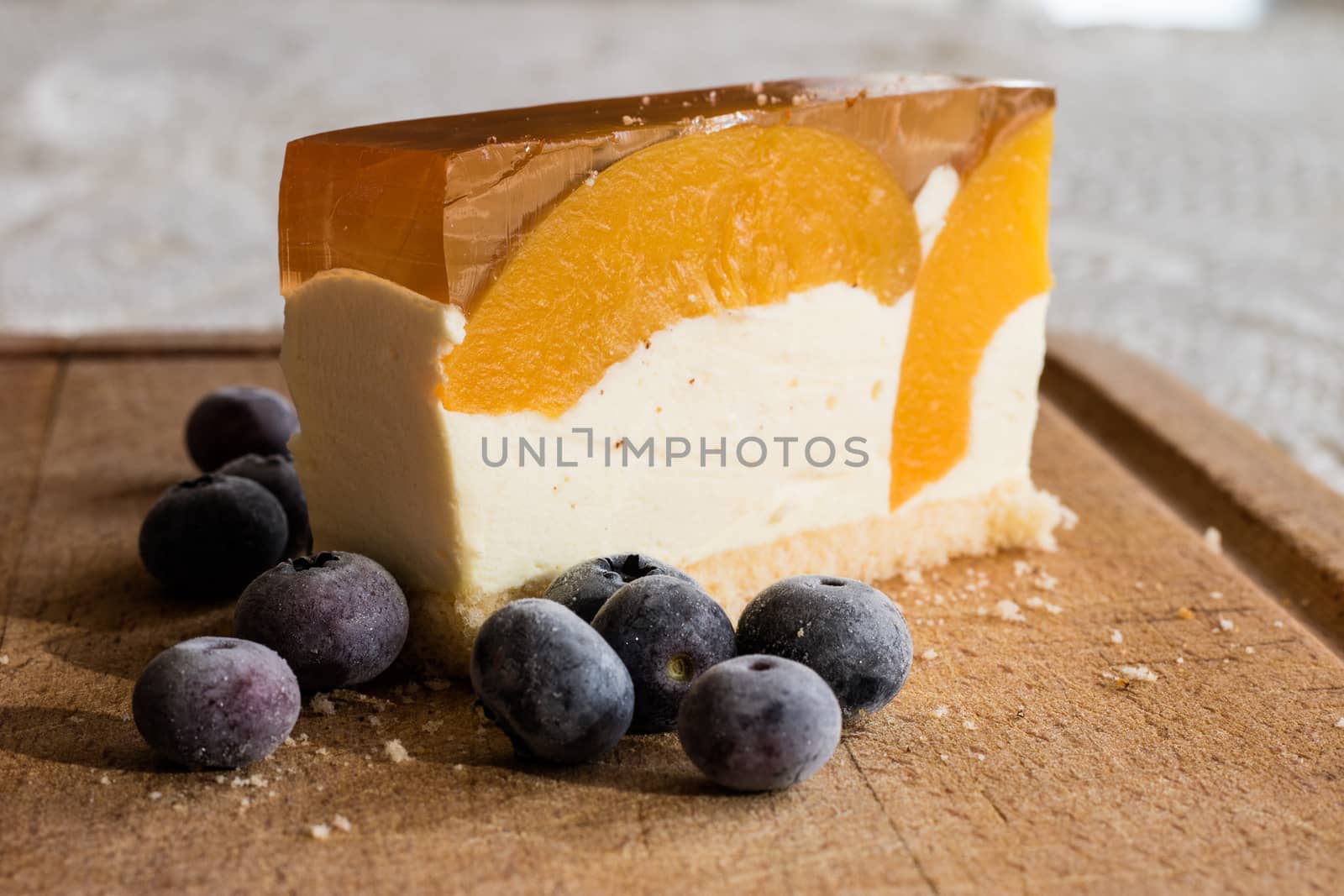 Delicious and sweet cake with blueberries. Sunny dessert on the kitchen table. Light background.