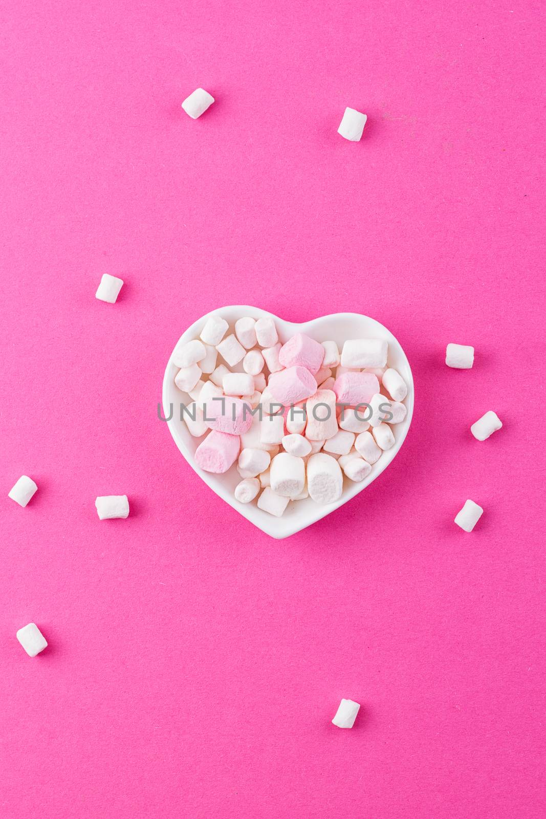 red heart-shaped plate with marshmallows, space for text, congratulations on Valentine's Day, top view