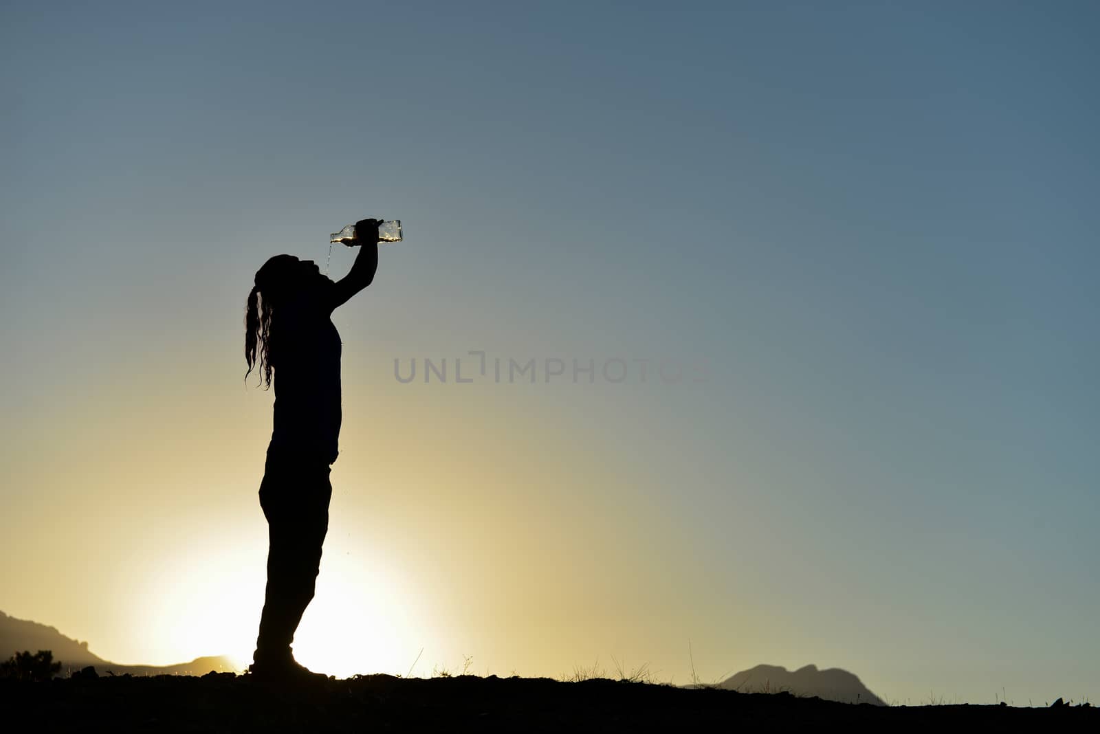 Man drinking water in scorching summer heat