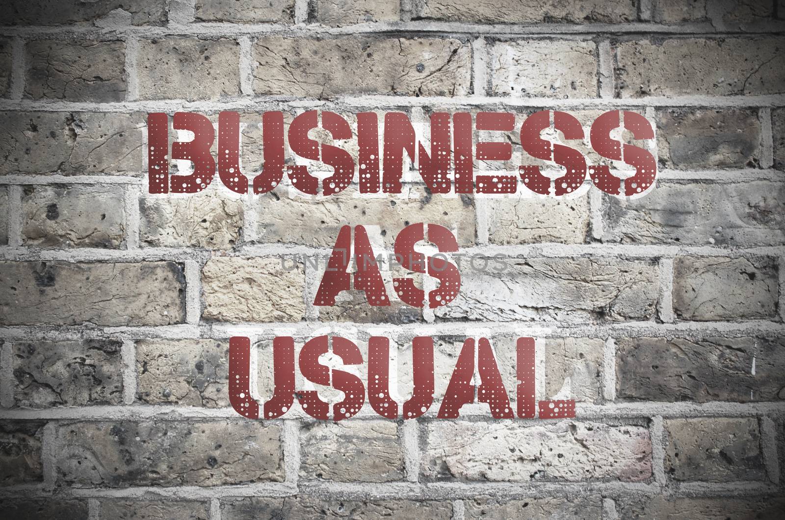 Business as usual painted sign on a brick wall