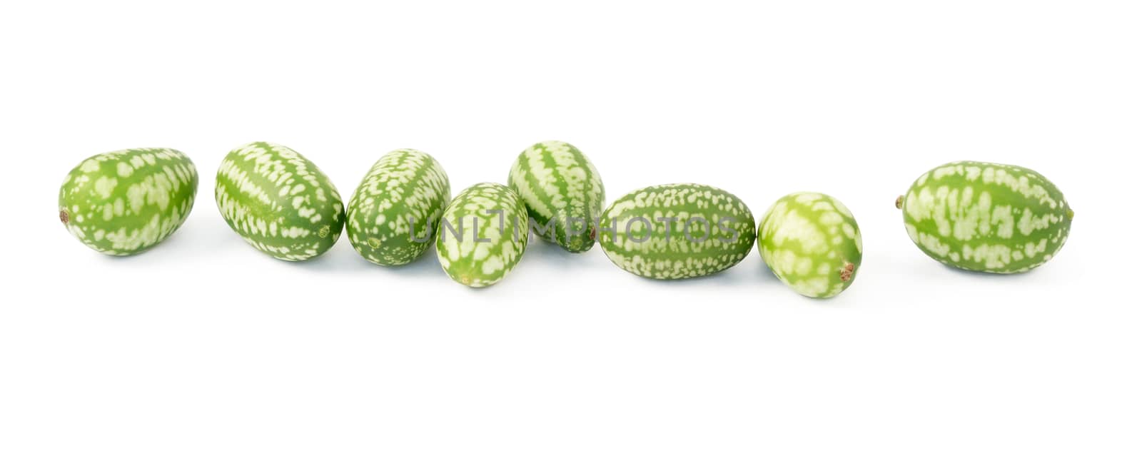 Row of eight cucamelons, Mexican sour gherkin, pepquino, or mouse melon, isolated on a white background