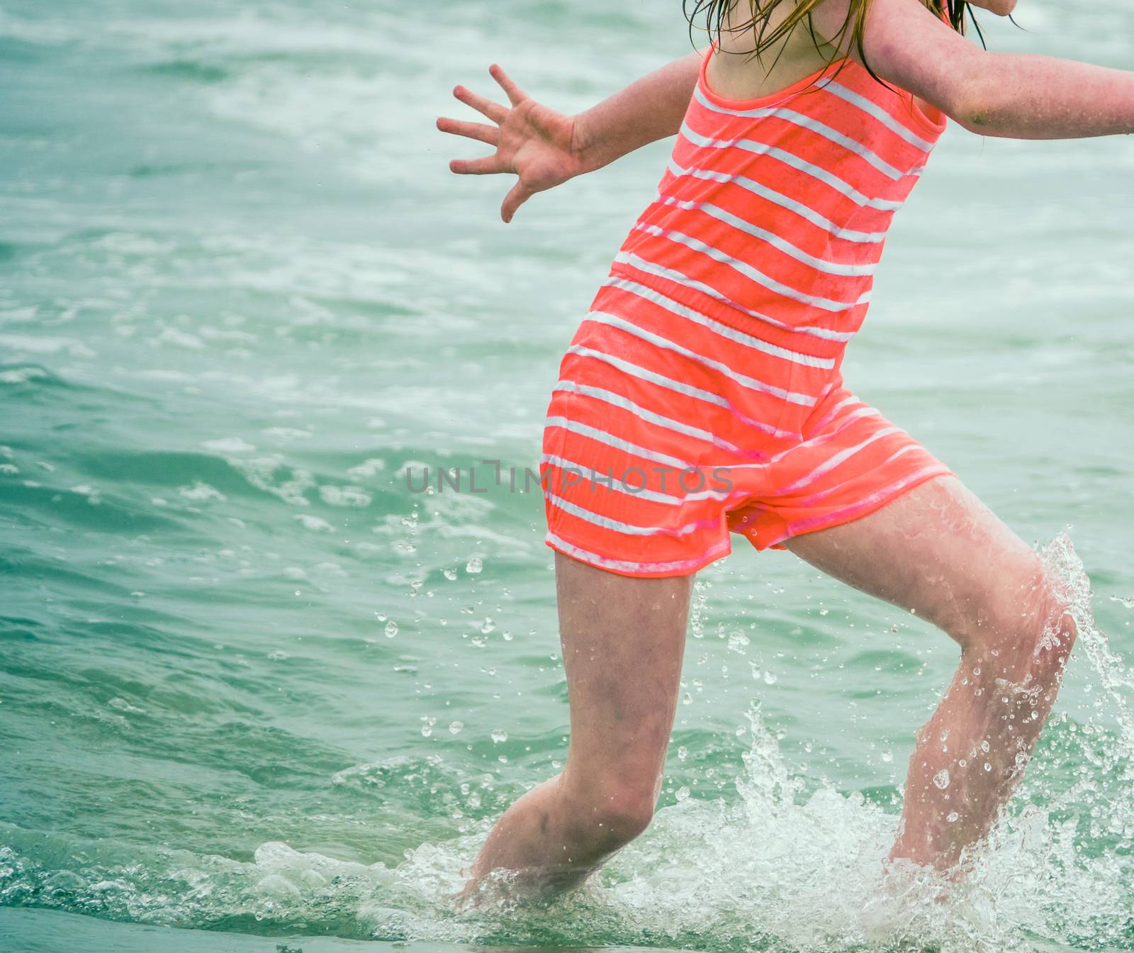 Retro Style Detail Of A Child In Old Fashioned Swimsuit Playing In The Ocean Waves