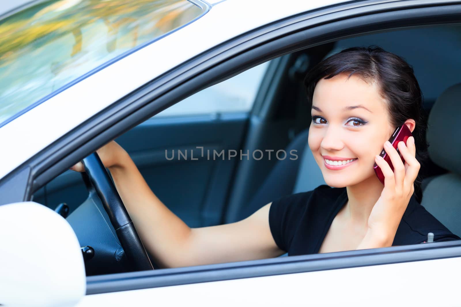 Woman driver using a mobile telephone