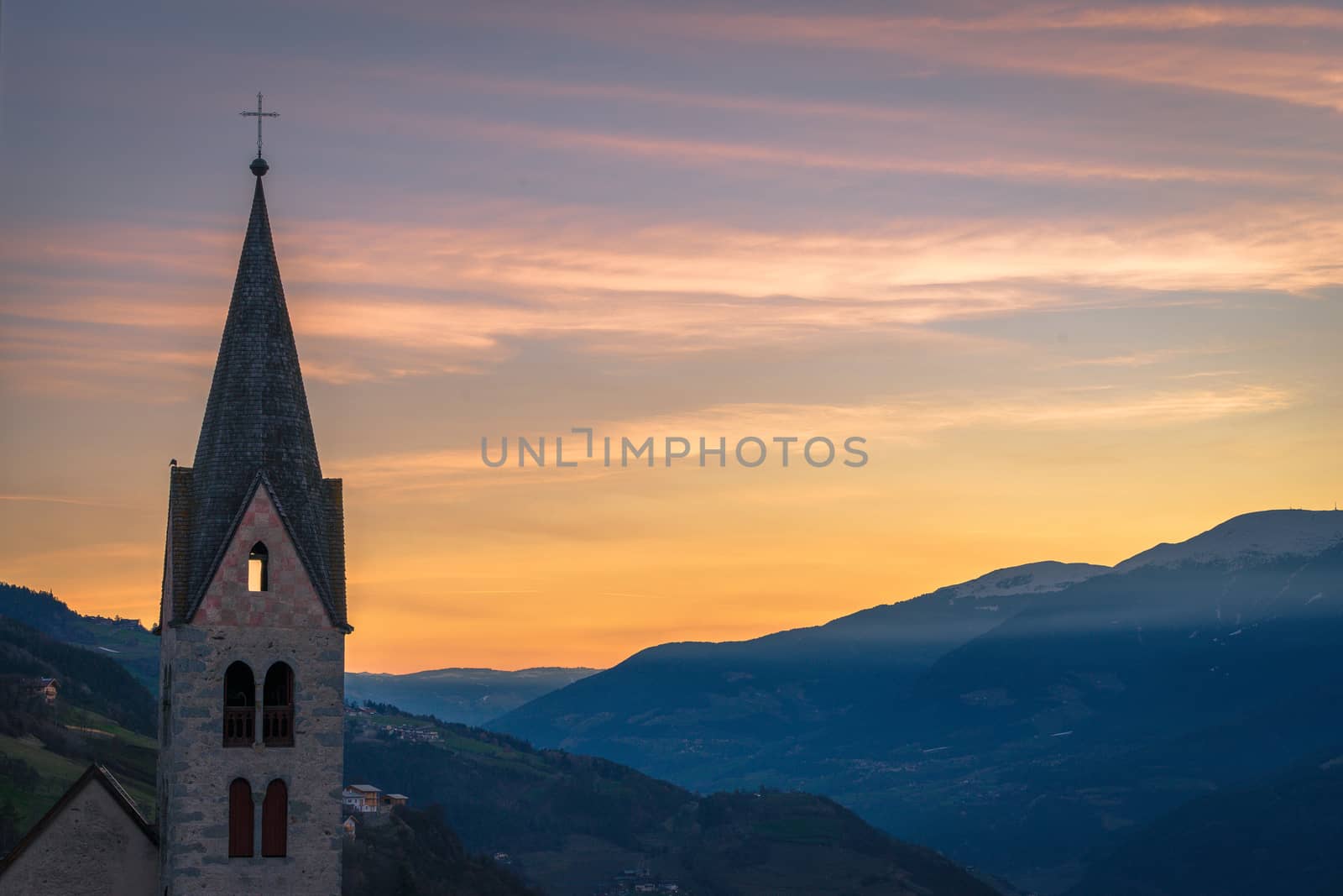 Belfry of the Parish Church in Villanders at Sunrise