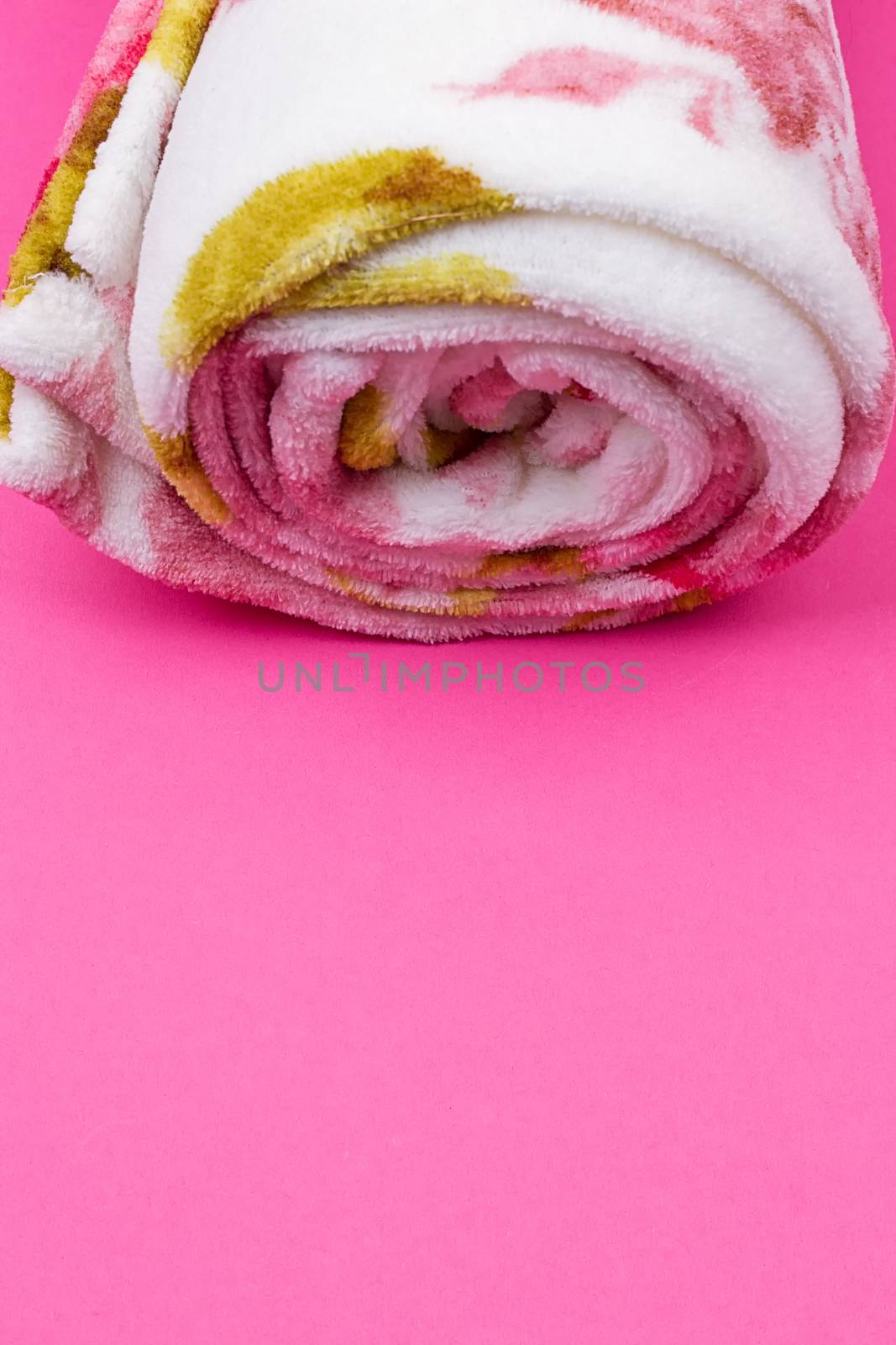Roll of plaid. Coiled plaid on the pink background