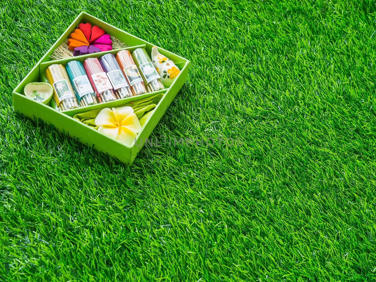 An incense set is placed on a green lawn.