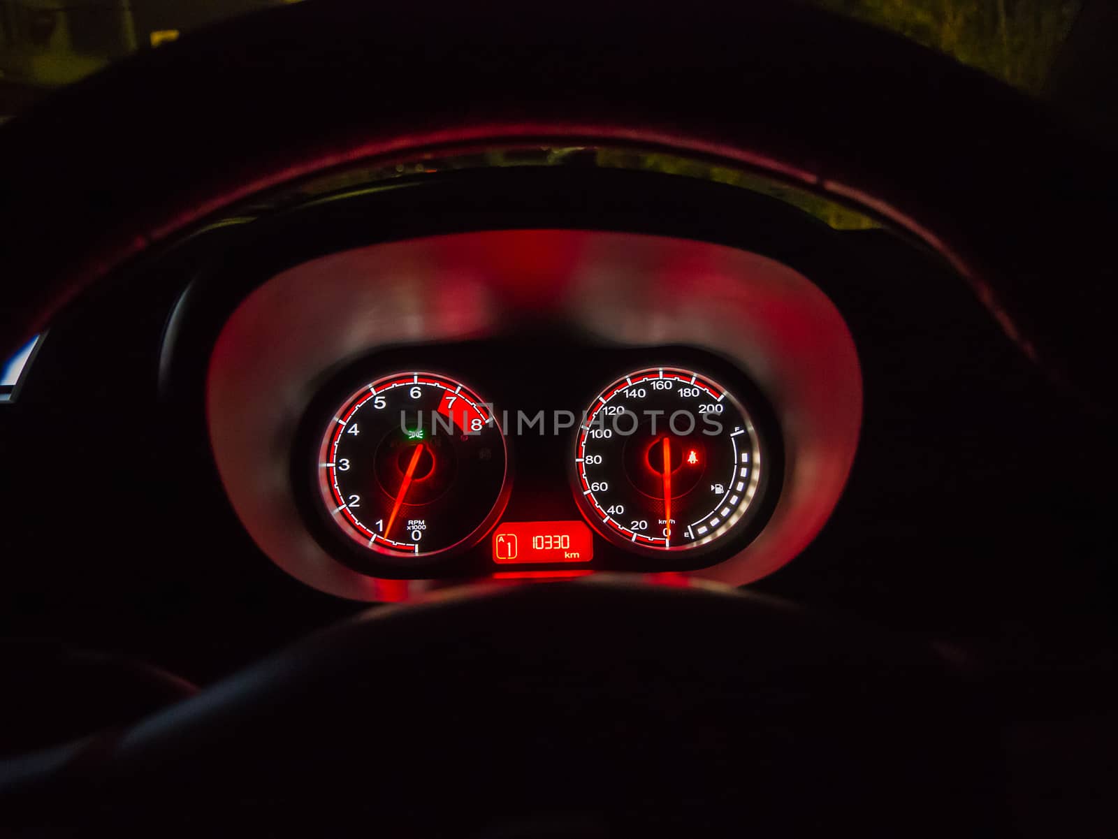 A close up of the front instrument panel or dashboard of a modern automobile.