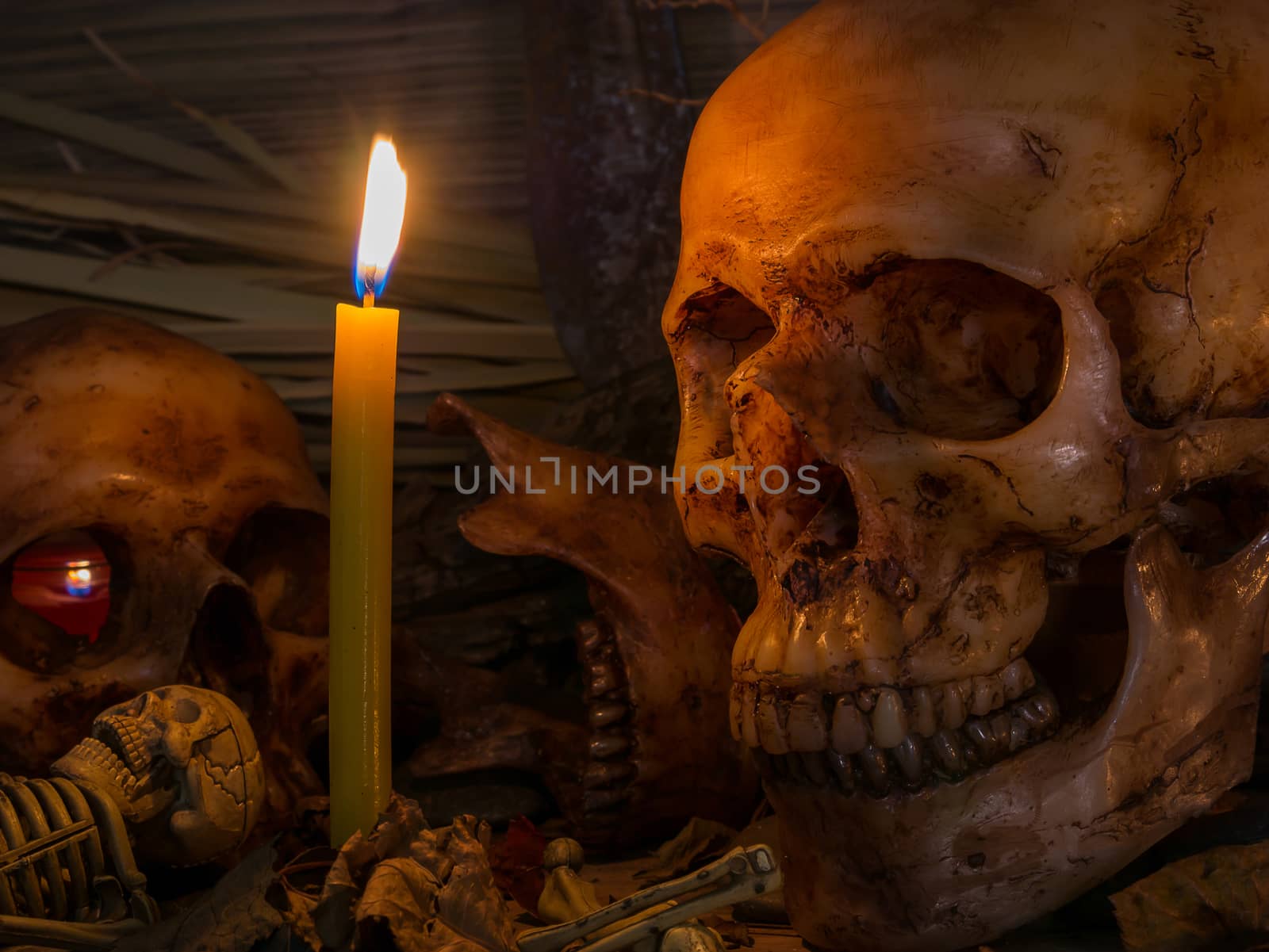 Candle with skull and apple on wood table background,Still life