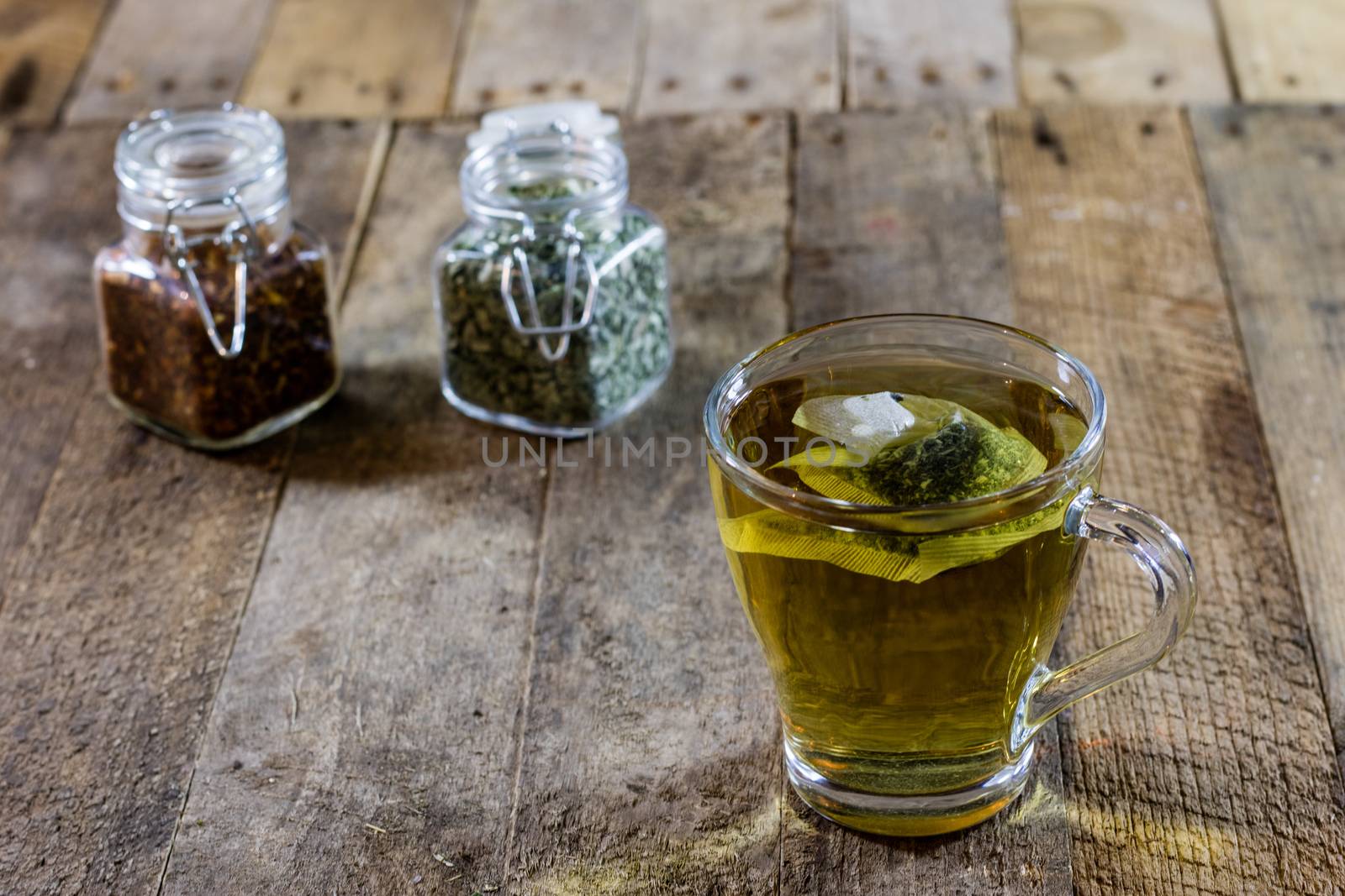 Tasty tea with nettles on a wooden table, black background