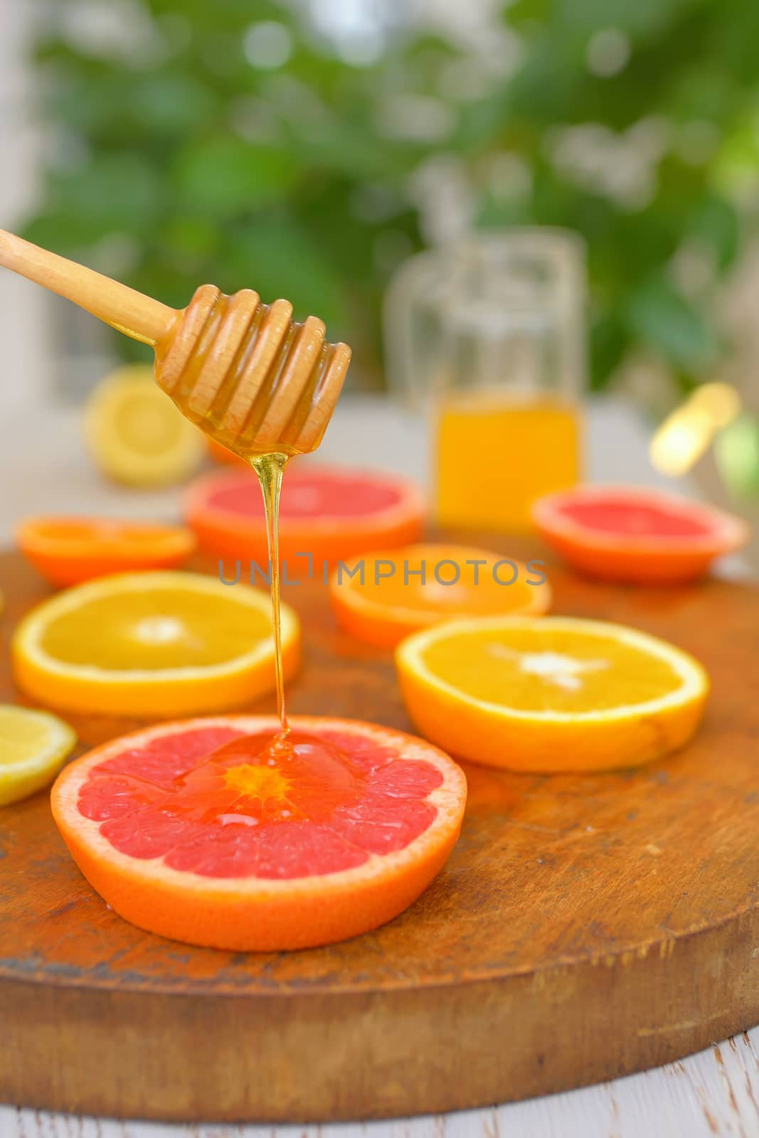 Slices of grapefruit, clementine, orange and honey