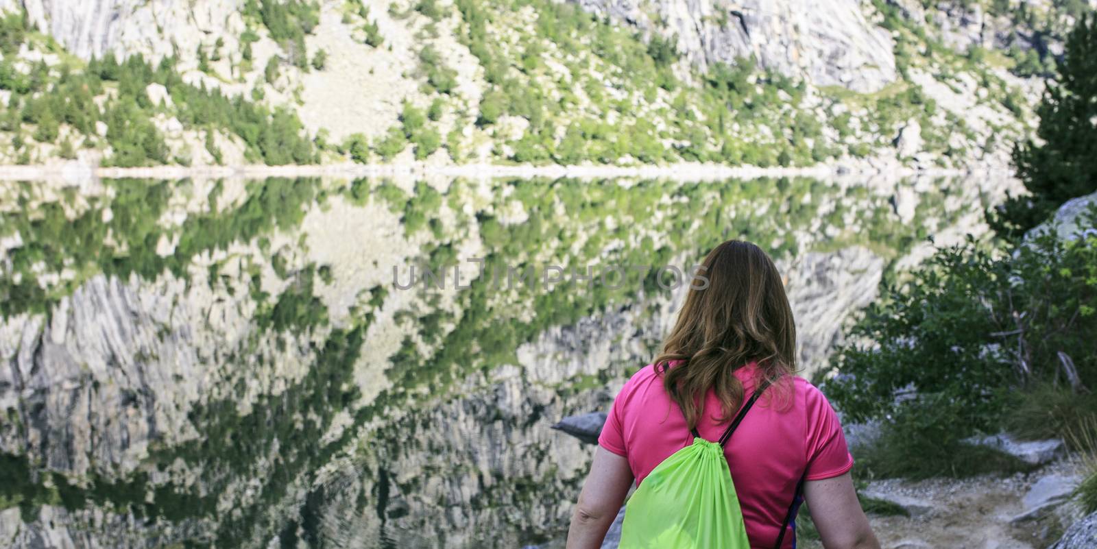 woman in a Mountains and lake photo with reflection