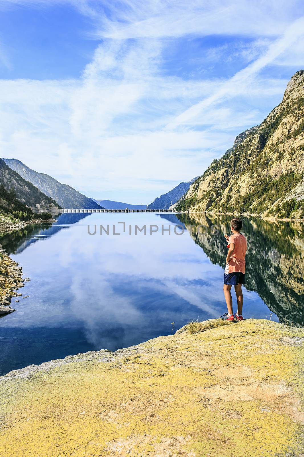 boy in a Mountains and lake photo with reflection