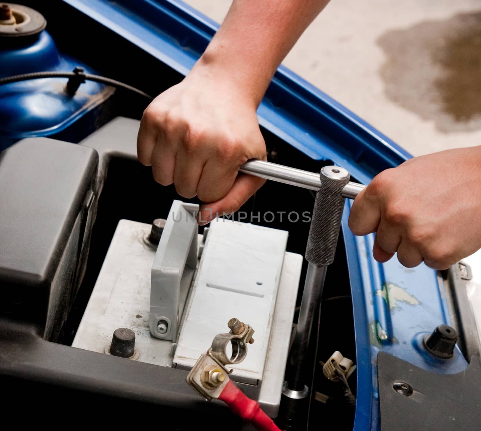 Mechanic at work, process of changing the car battery, closeup shot