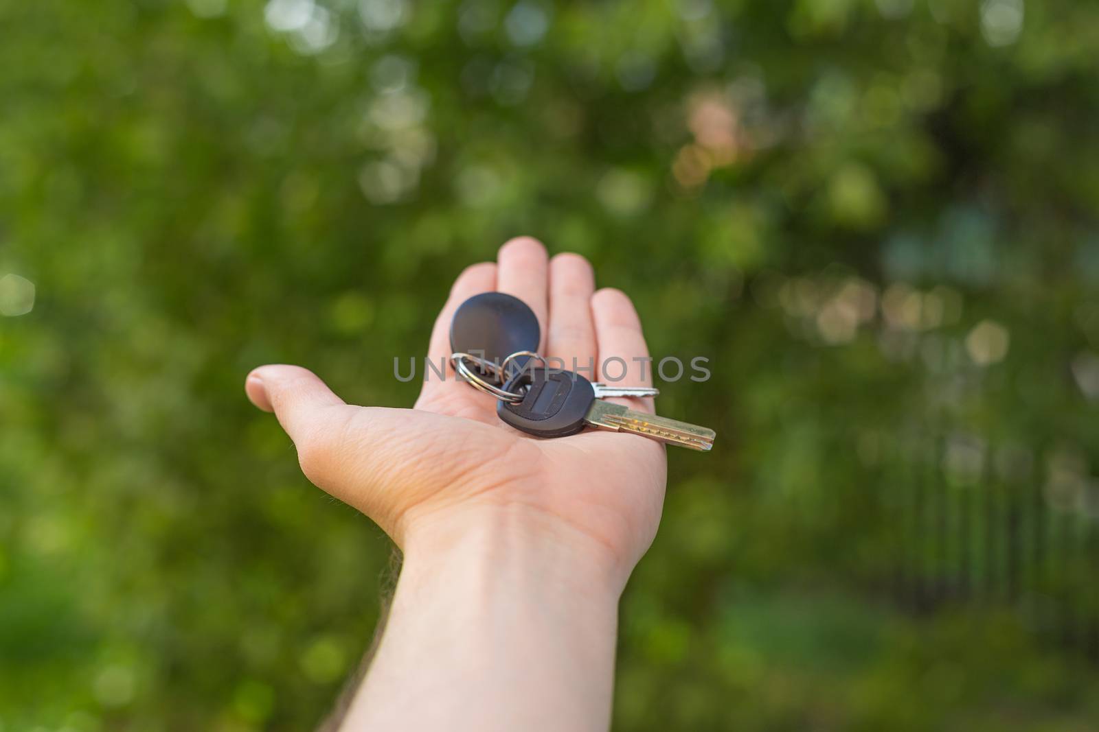 the guy holds the keys in hand close up