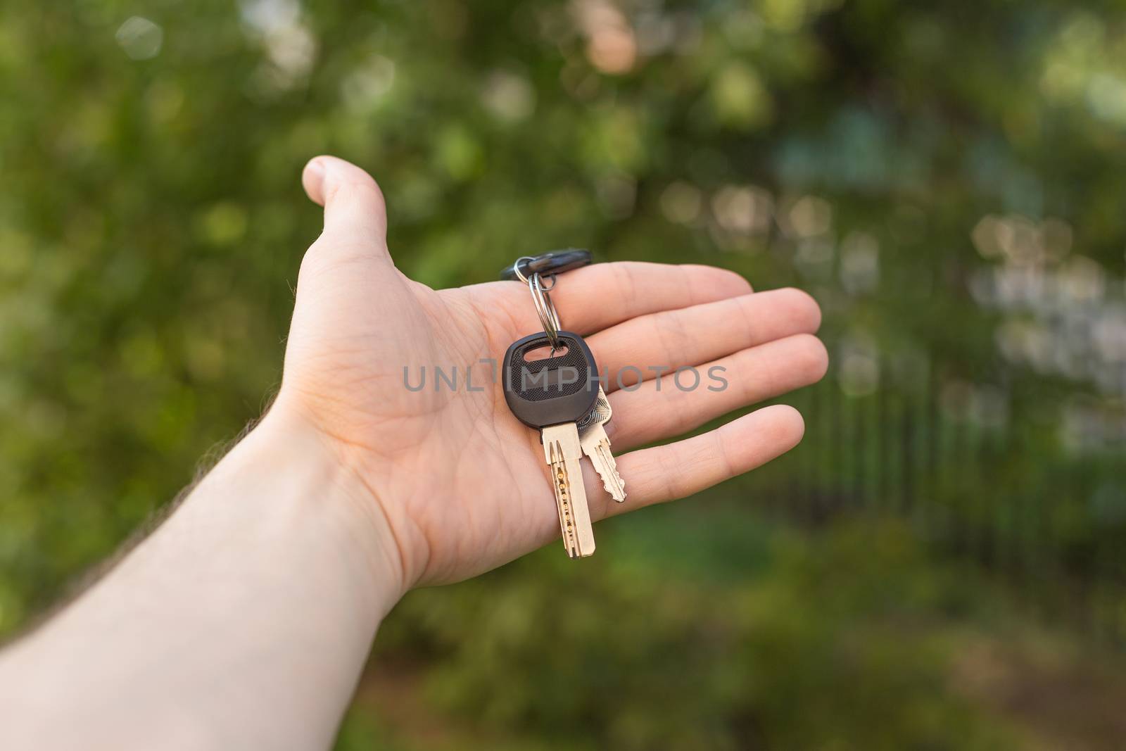 the guy holds the keys in hand close up