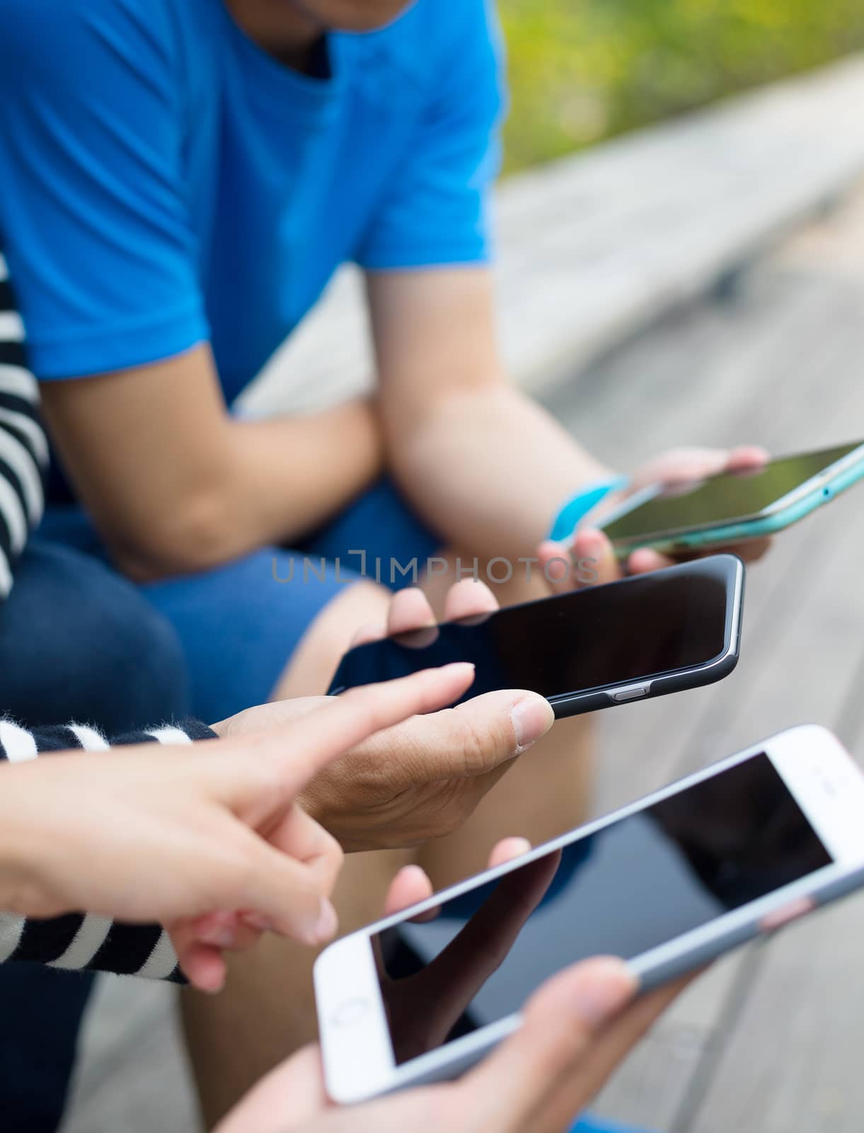 Friends using cellphone together by leungchopan