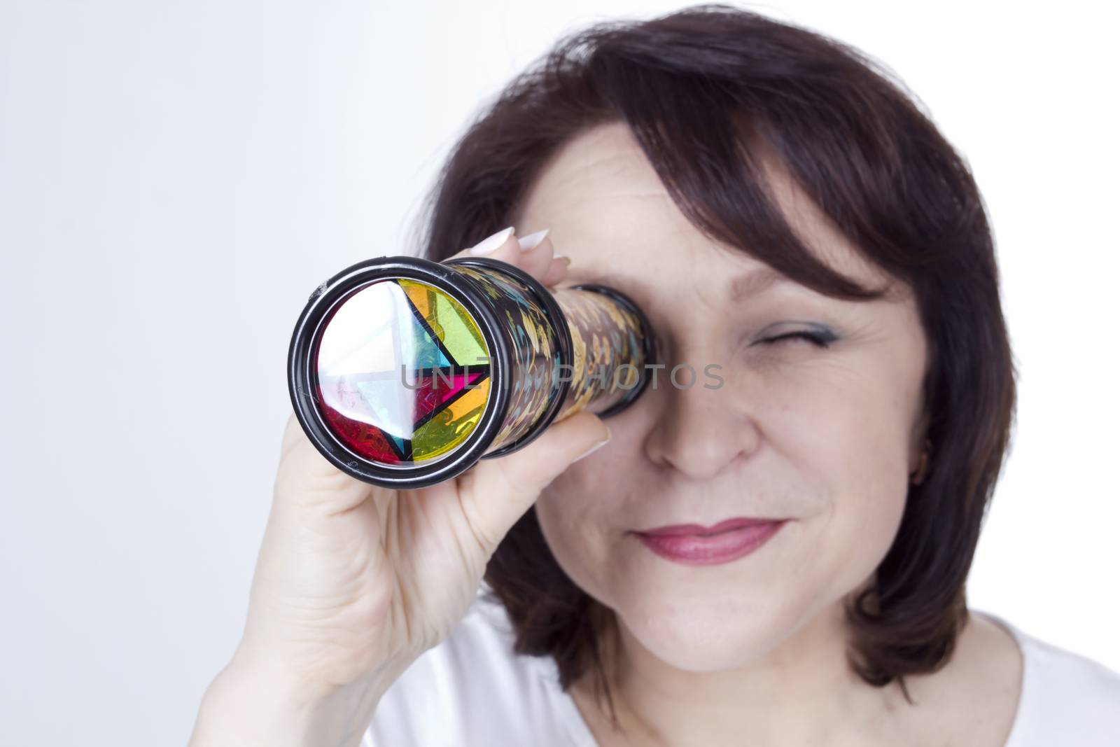 Adult woman looking into a kaleidoscope by VIPDesignUSA