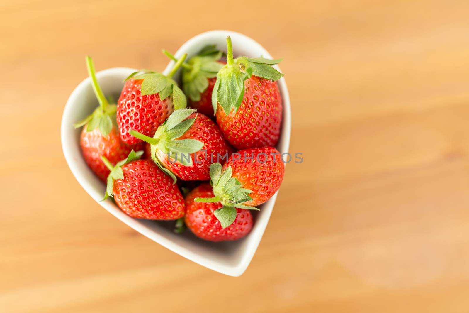 Strawberry in a heart shape bowl