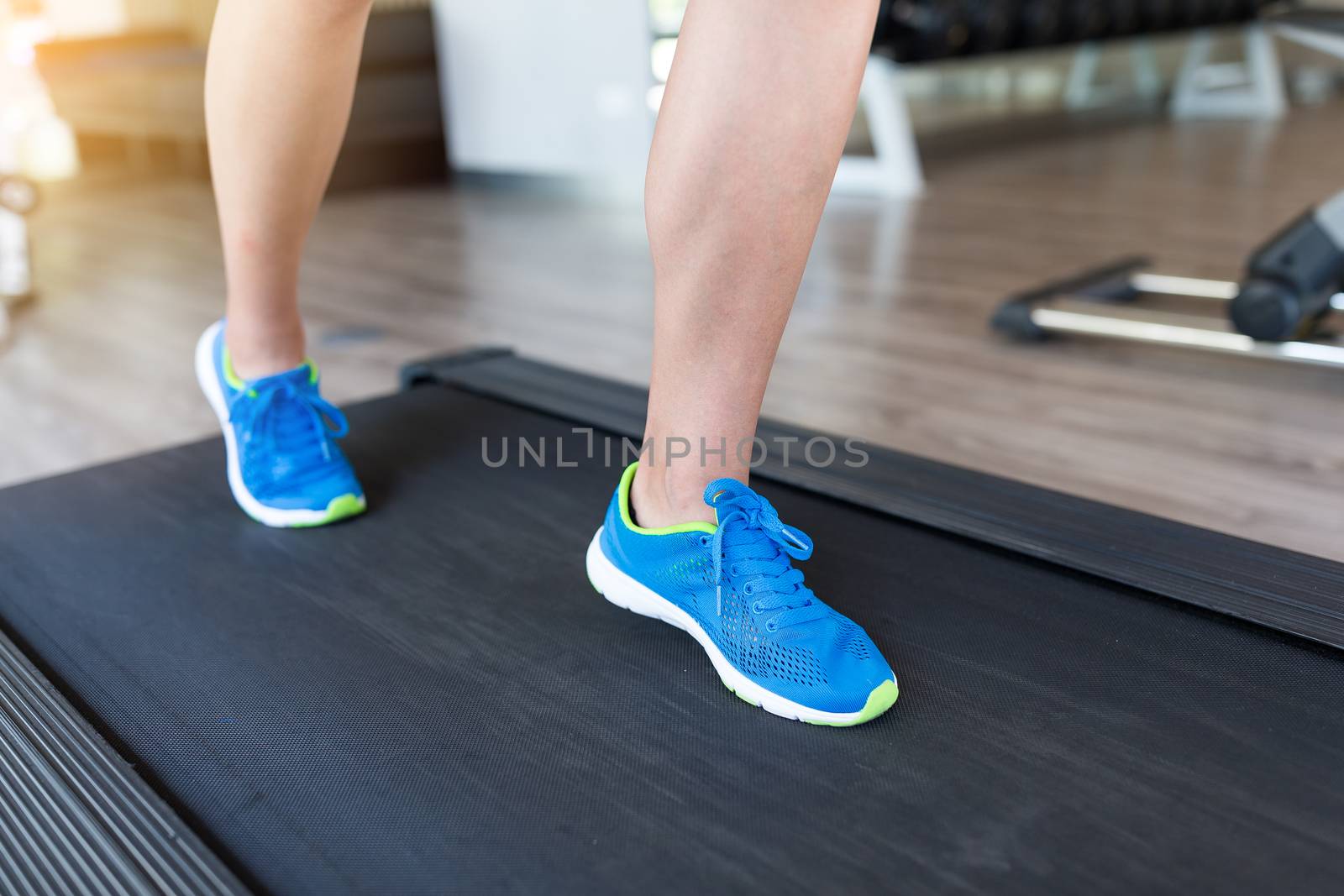 Woman running on treadmill by leungchopan