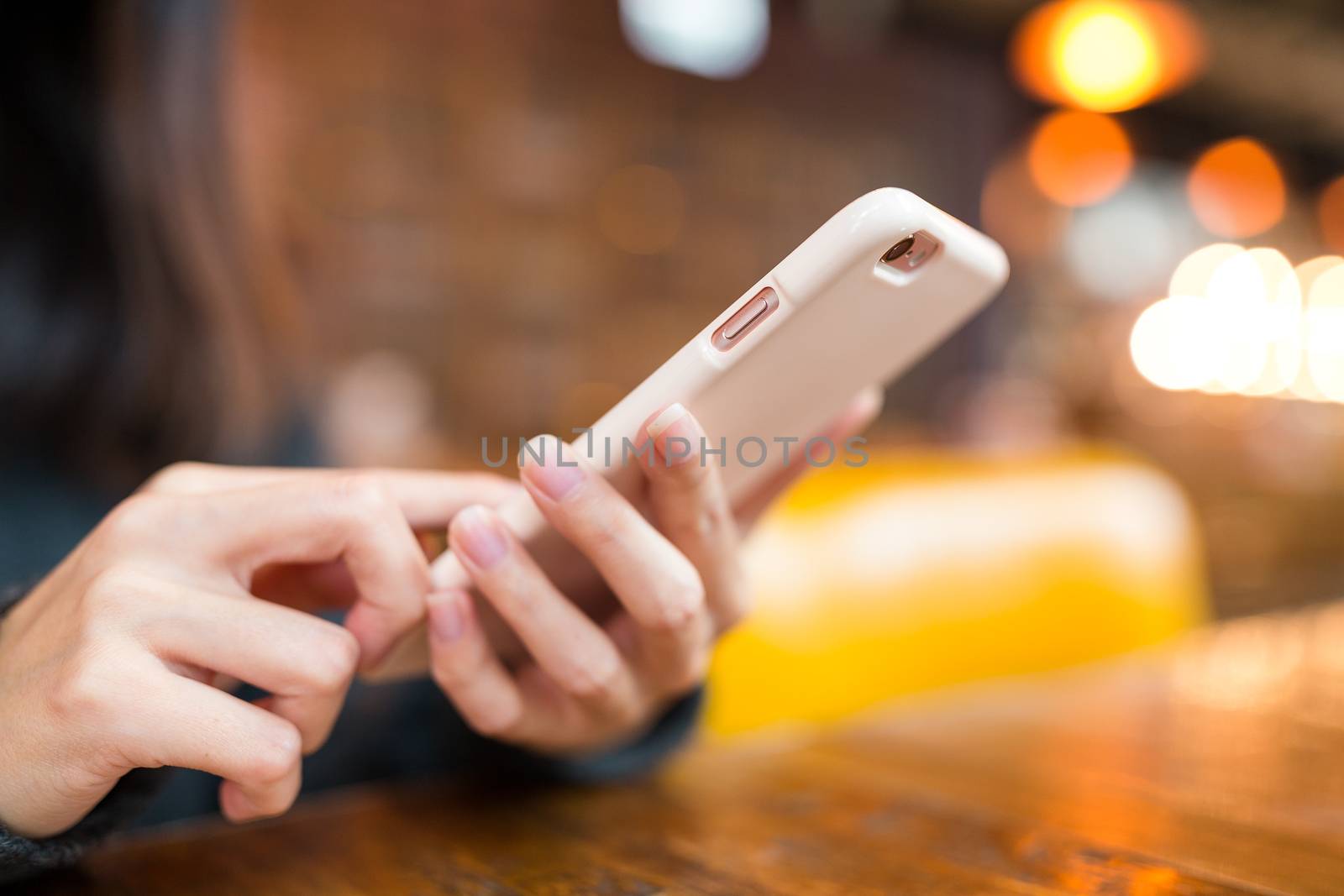 Woman working on cellphone by leungchopan