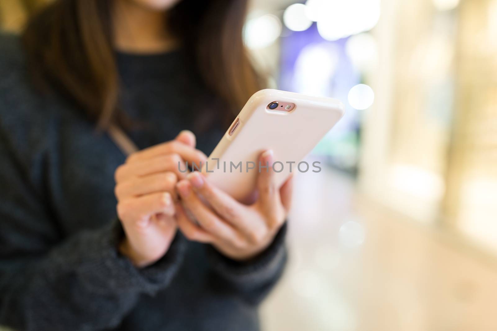 Woman sending sms on mobile phone