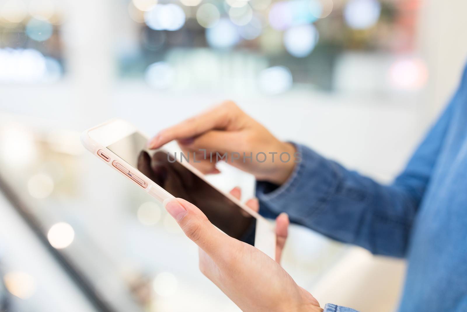 Woman working on cellphone by leungchopan