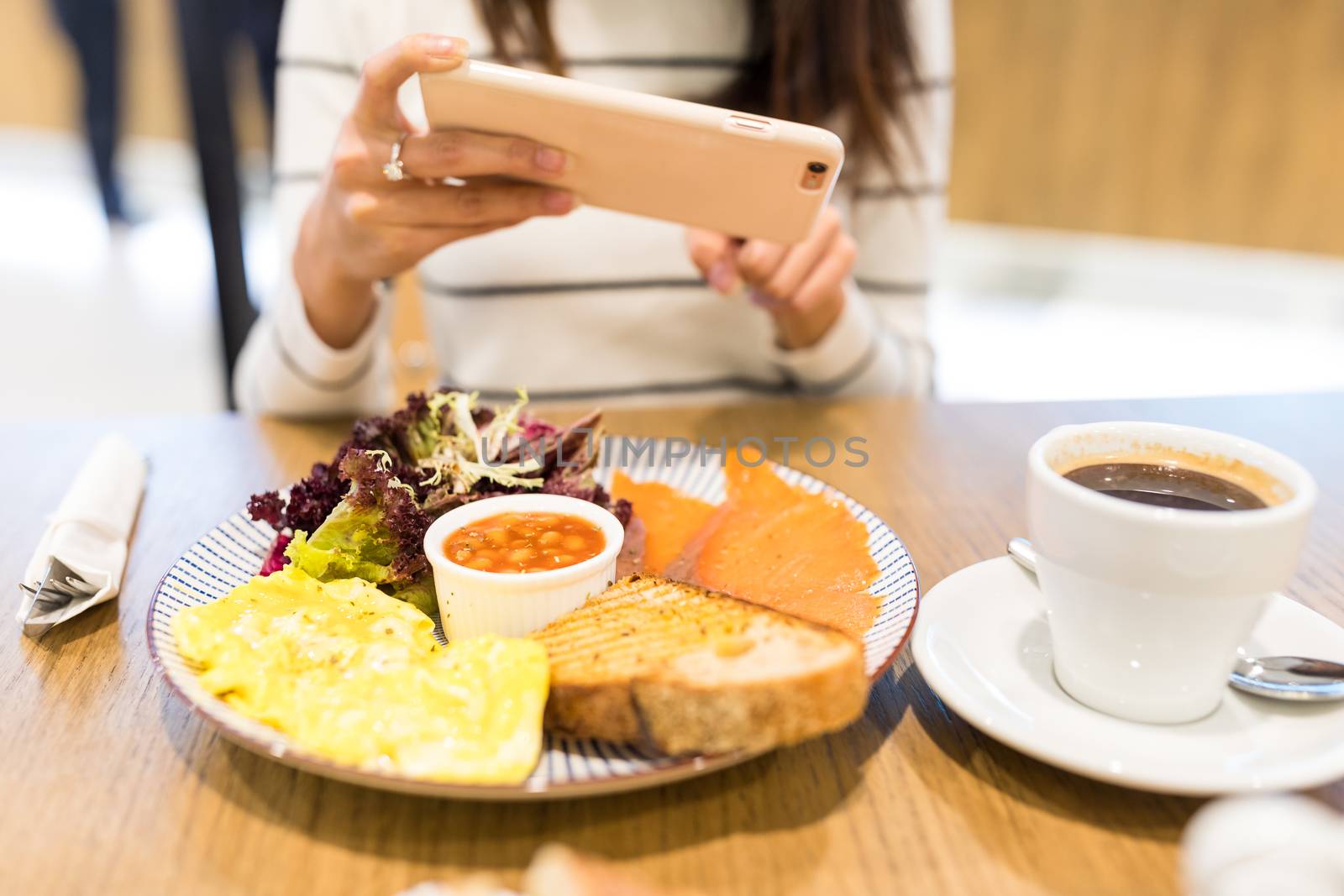 Woman taking photo on her meal by leungchopan