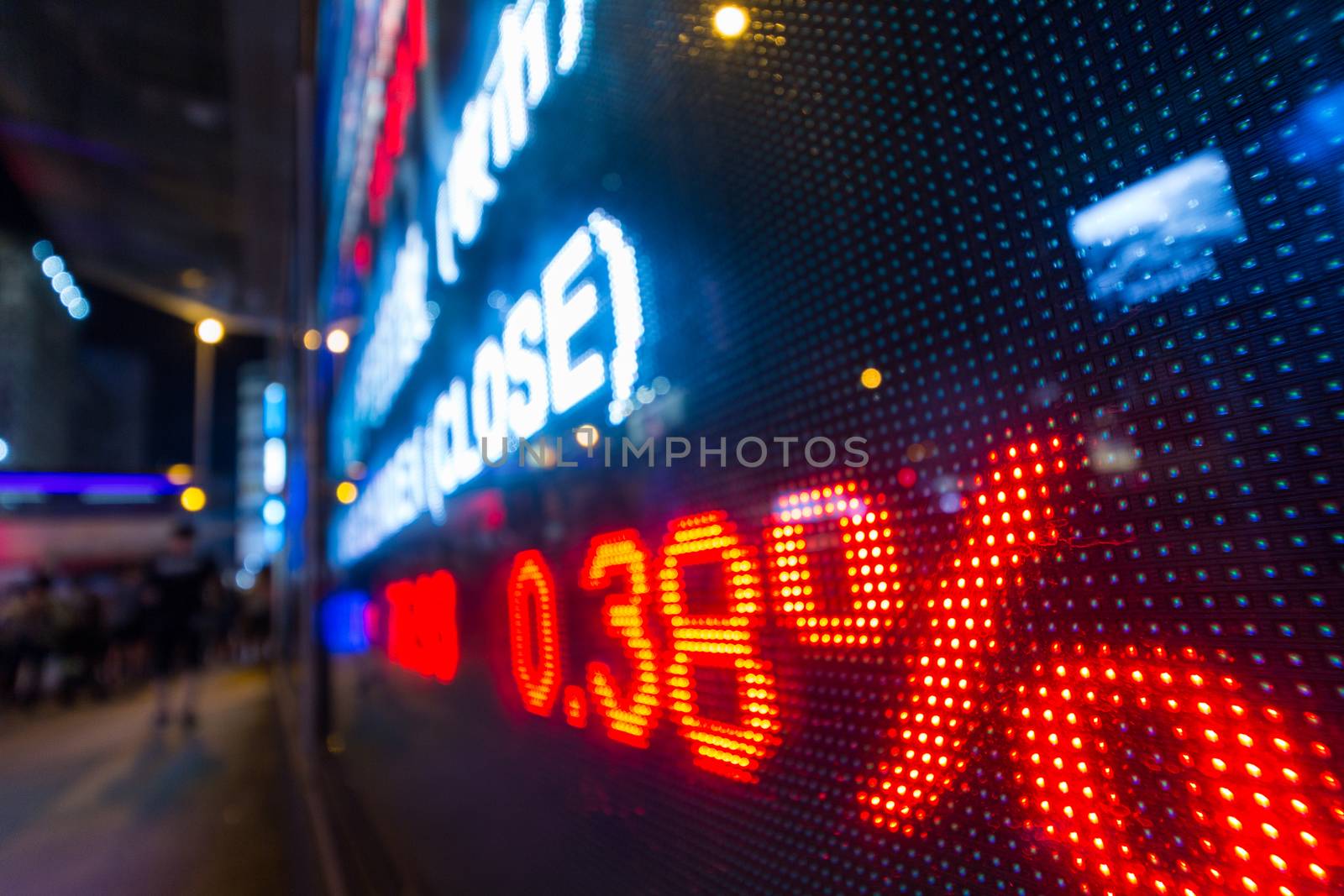 Stock market display in the street at night by leungchopan