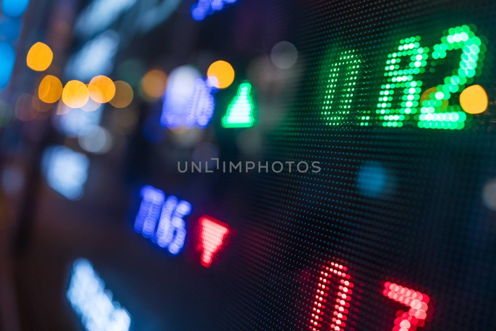 Stock index numbers with city scene reflect on glass