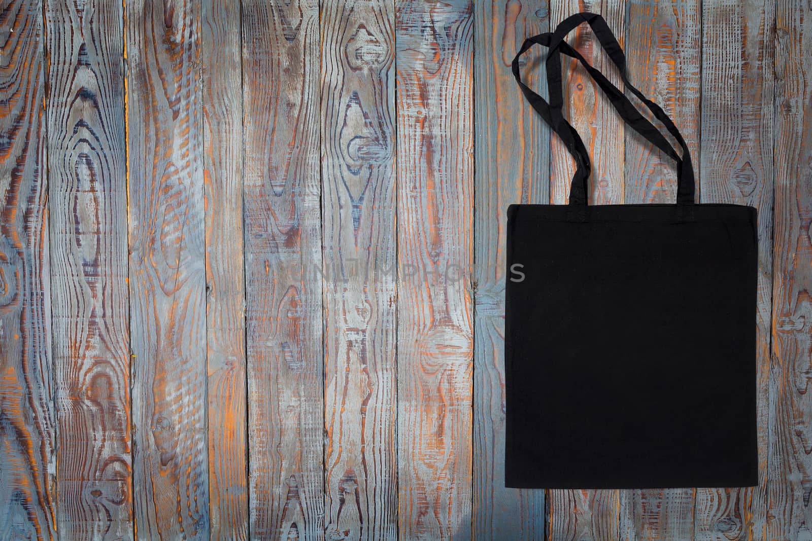 black cotton bag for shopping on a wooden background