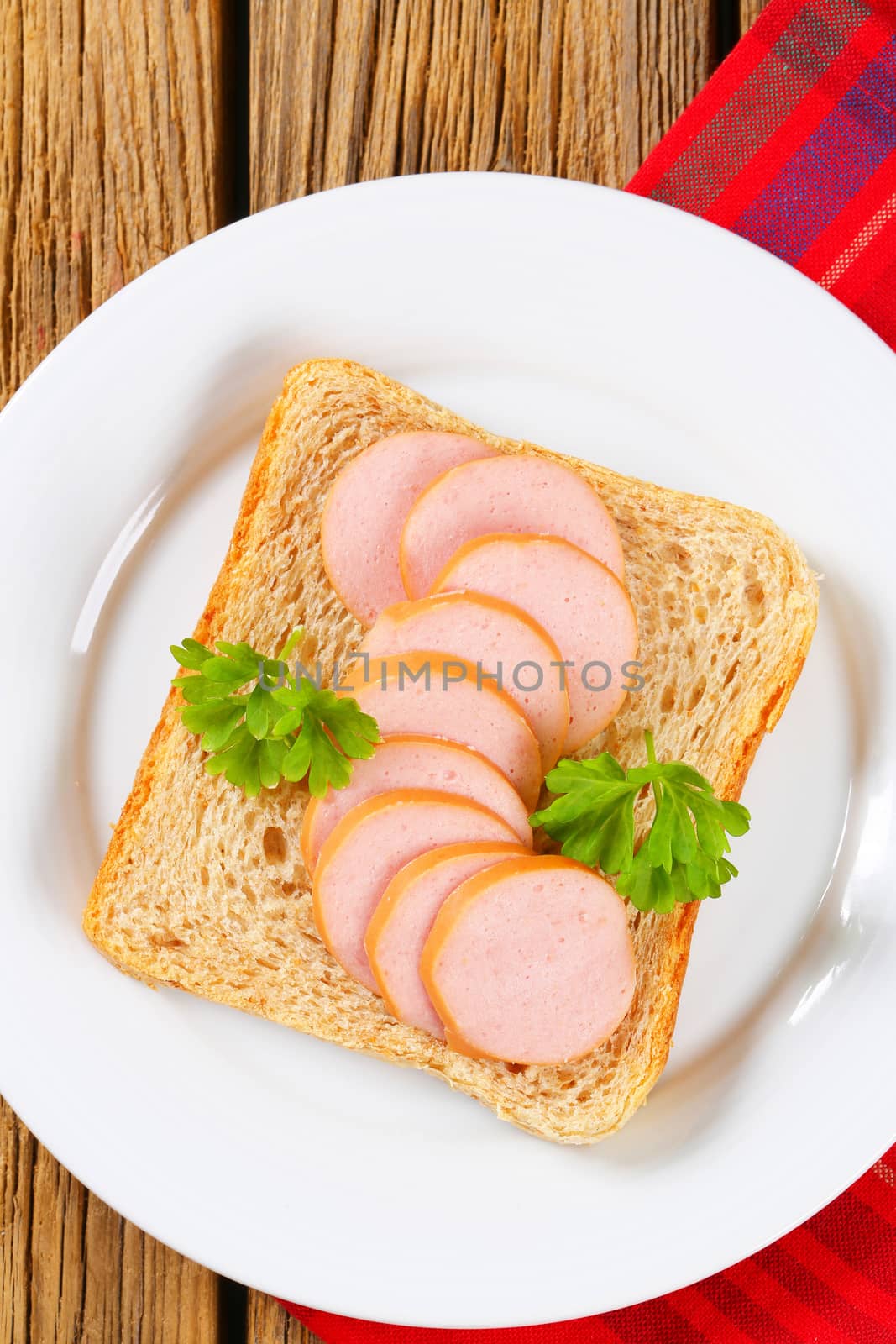 Whole wheat bread with slices of lean sausage