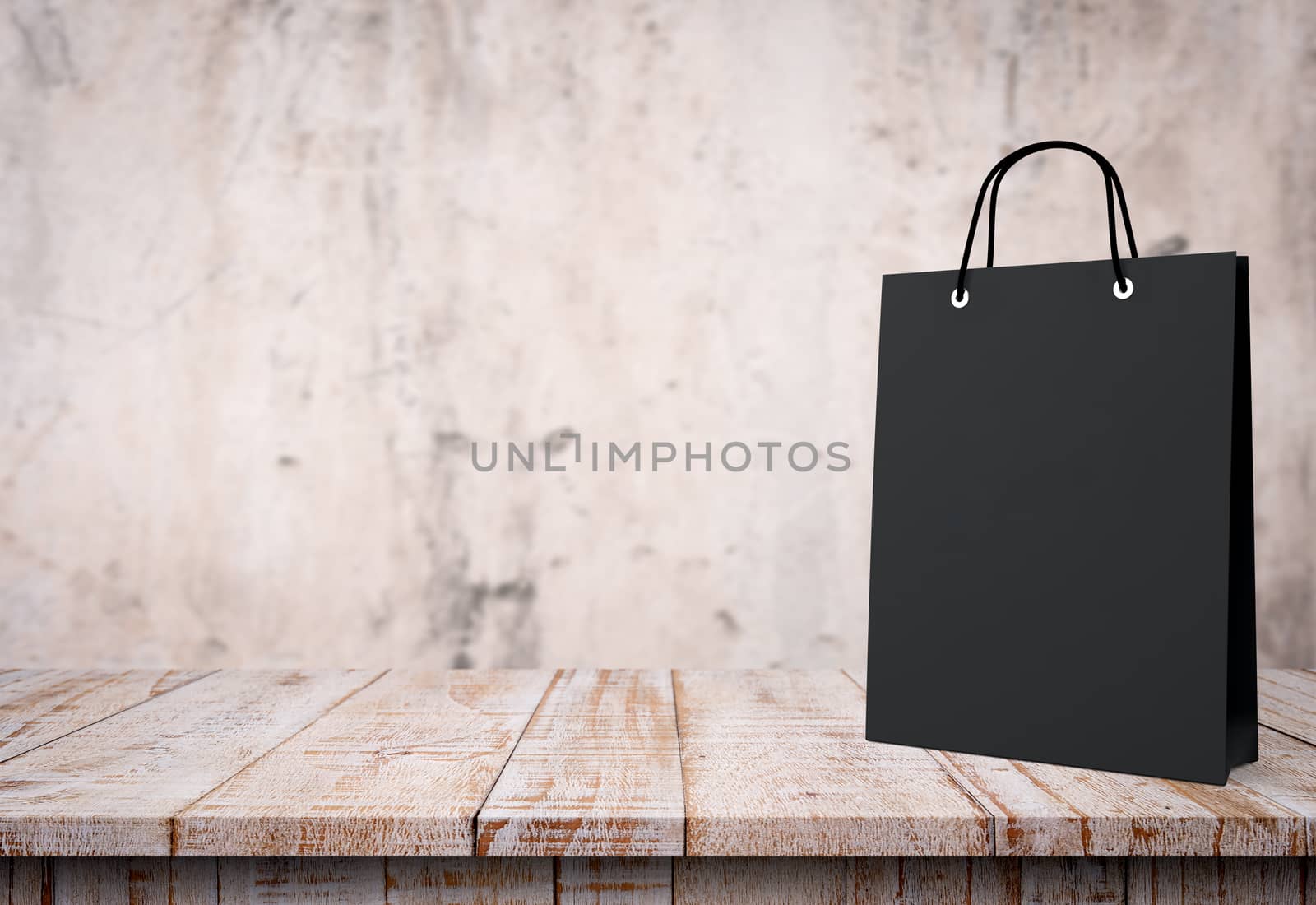 black paper bag for shopping on a wooden background