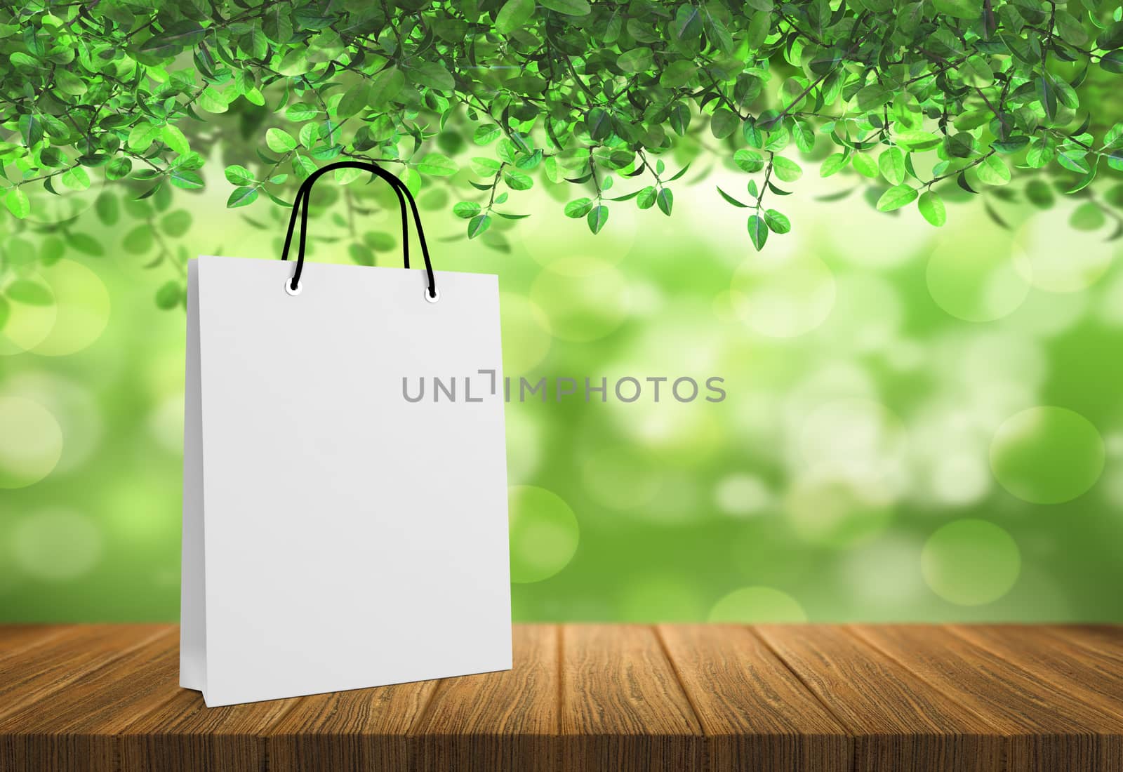 white paper bag for shopping on a wooden background by boys1983@mail.ru