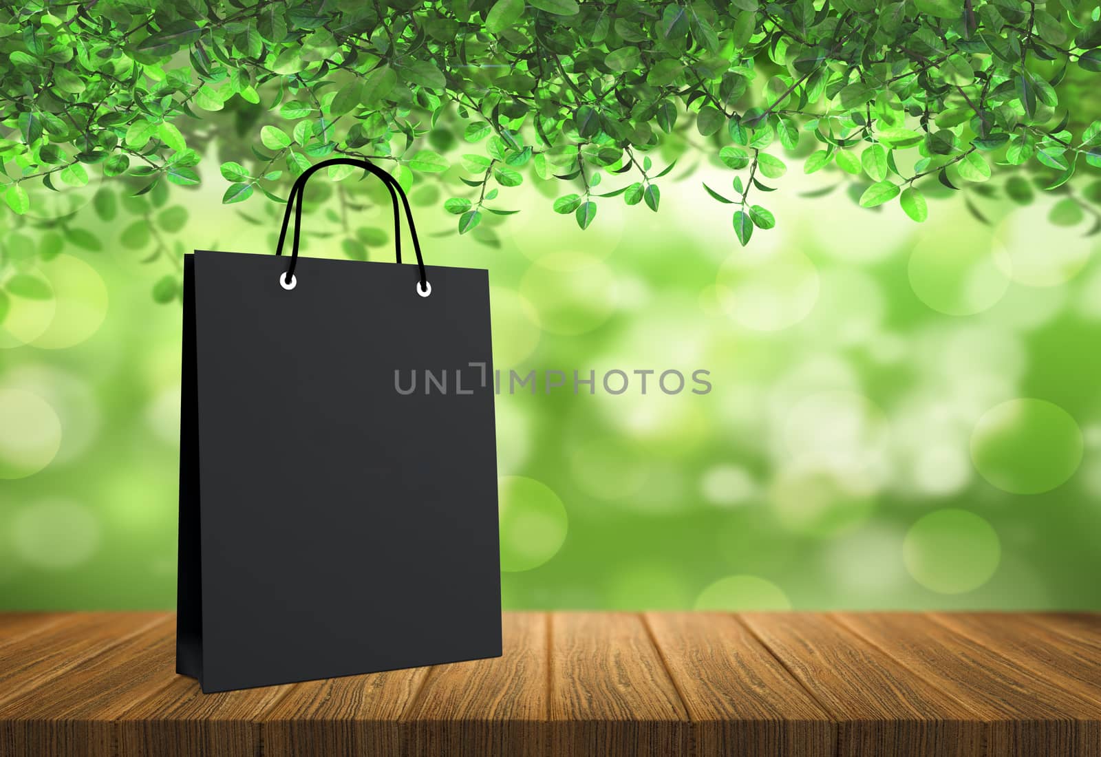 black paper bag for shopping on a wooden background