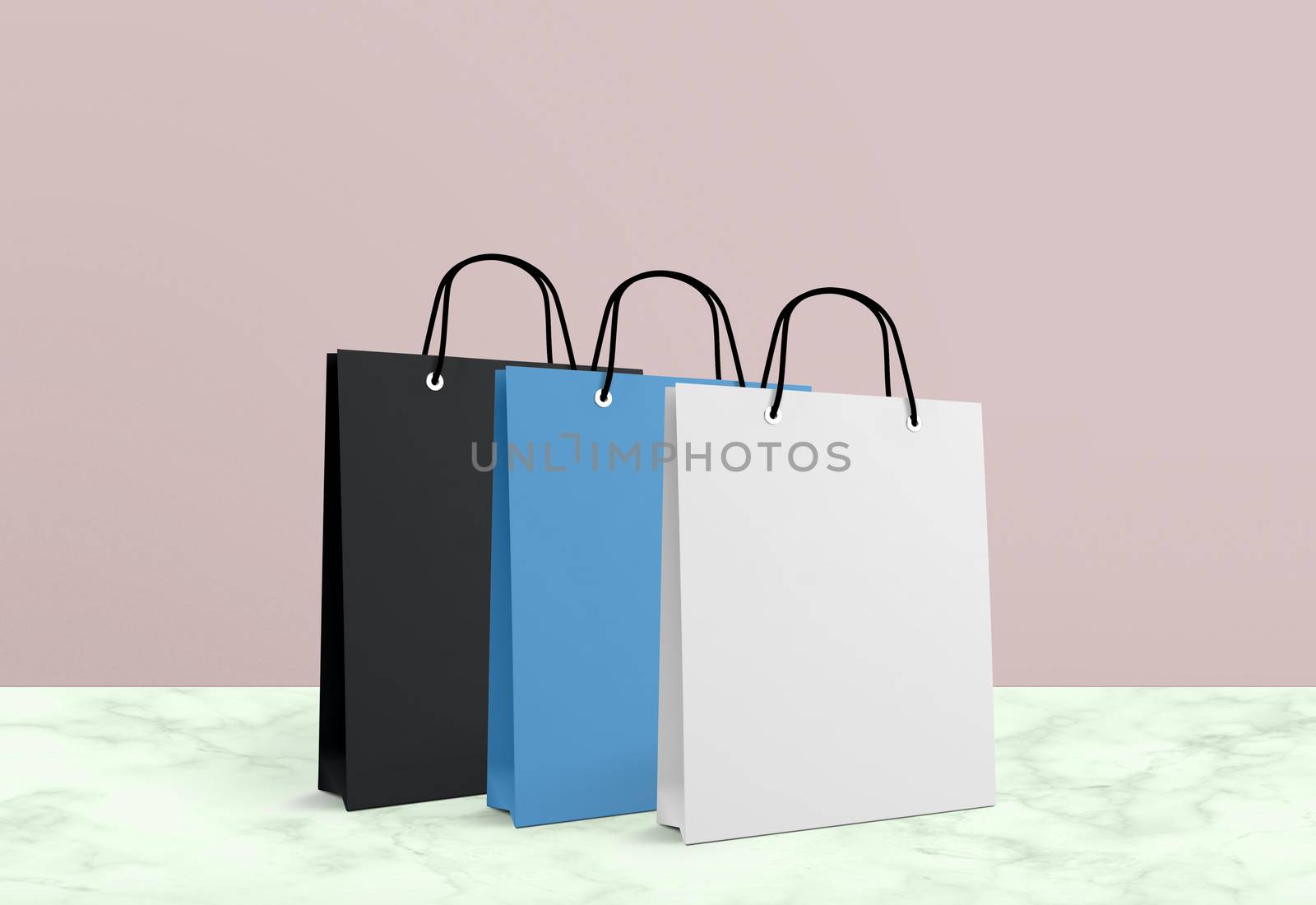 three paper bags for shopping on a pink background