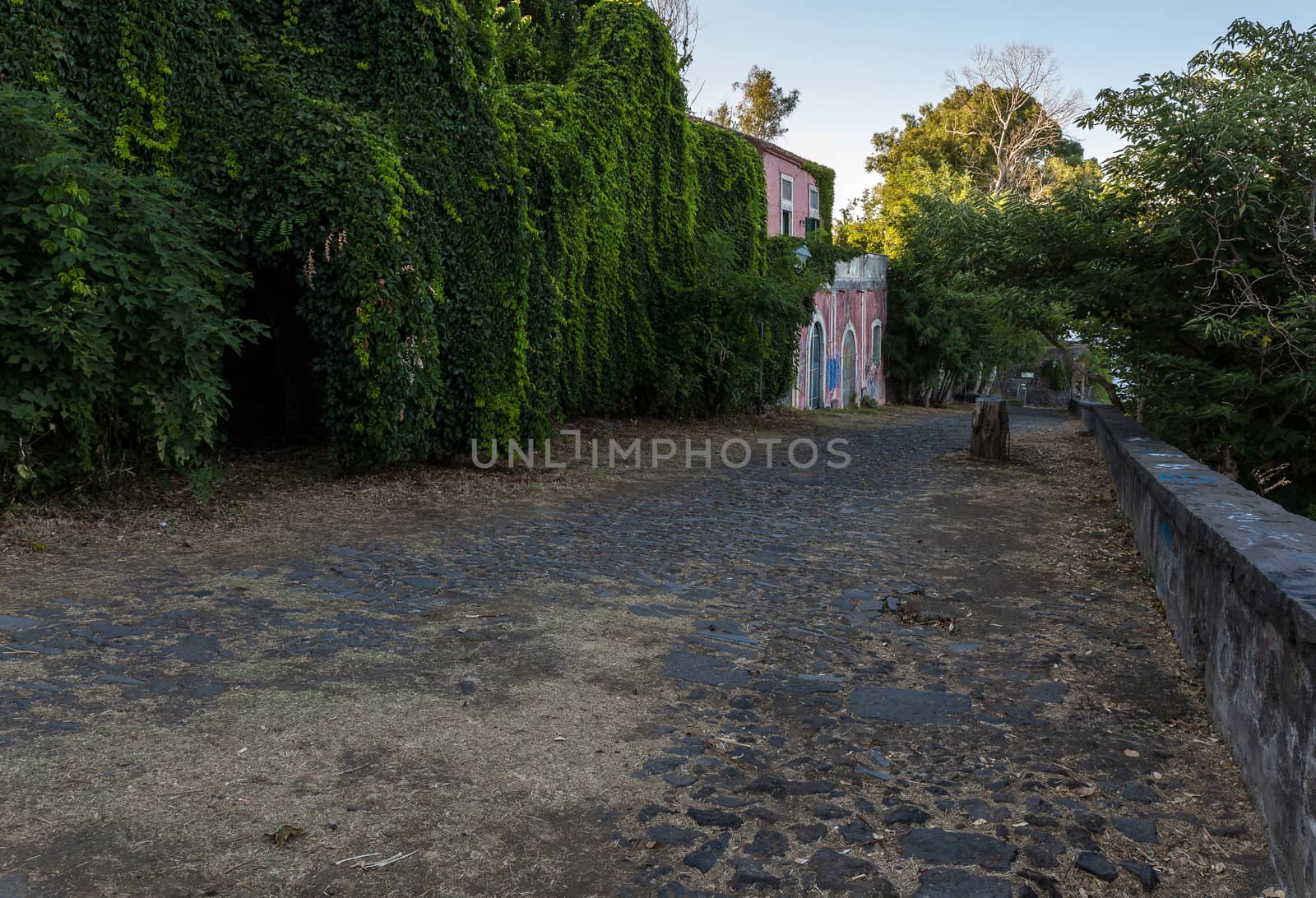 Country road in Sicily with ancient colonial house