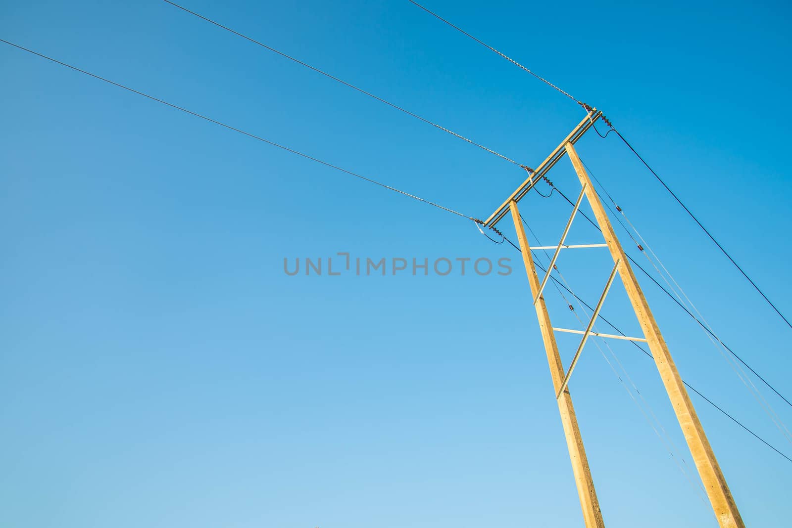 Electricity post and a blue sky background.