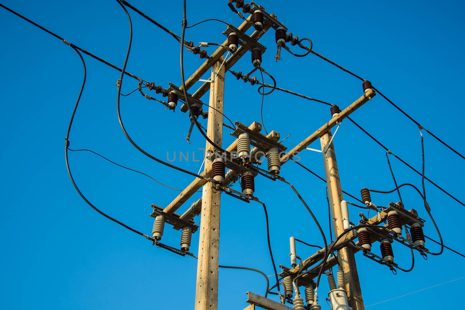 Electricity post and a blue sky background.