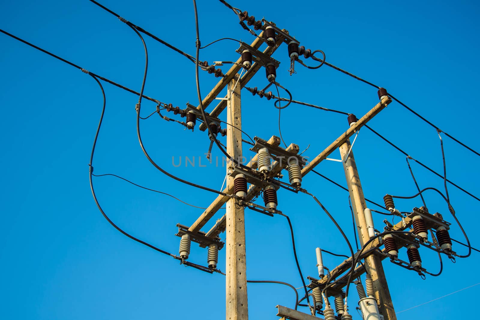 Electricity post and a blue sky background.