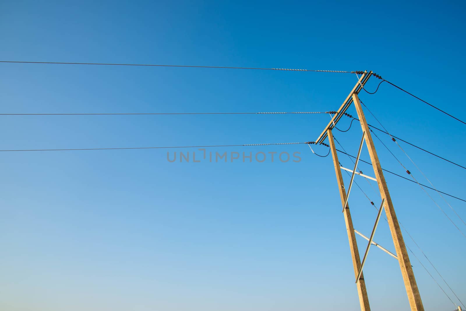 Electricity post and a blue sky background.