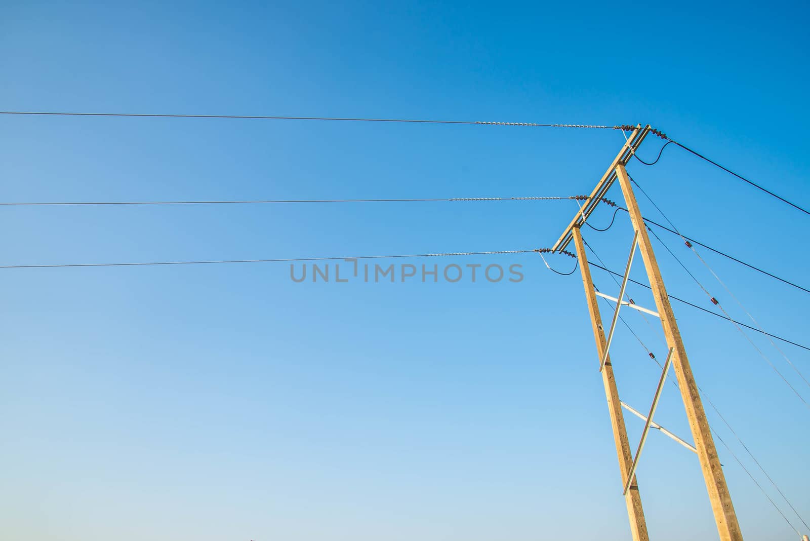 Electricity post and a blue sky background.